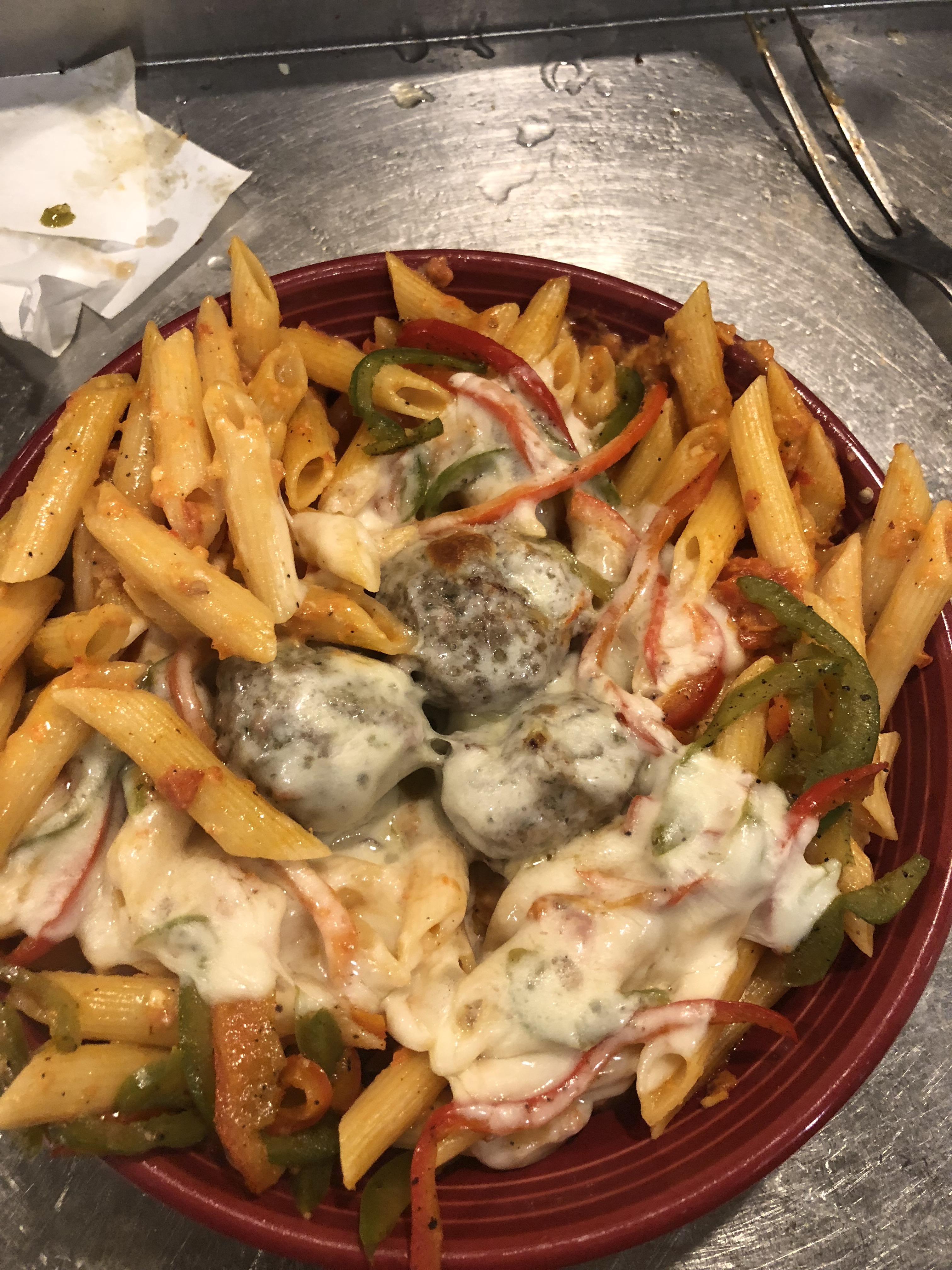 Penne pasta tossed in spicy sugo with sautéed green and red bell