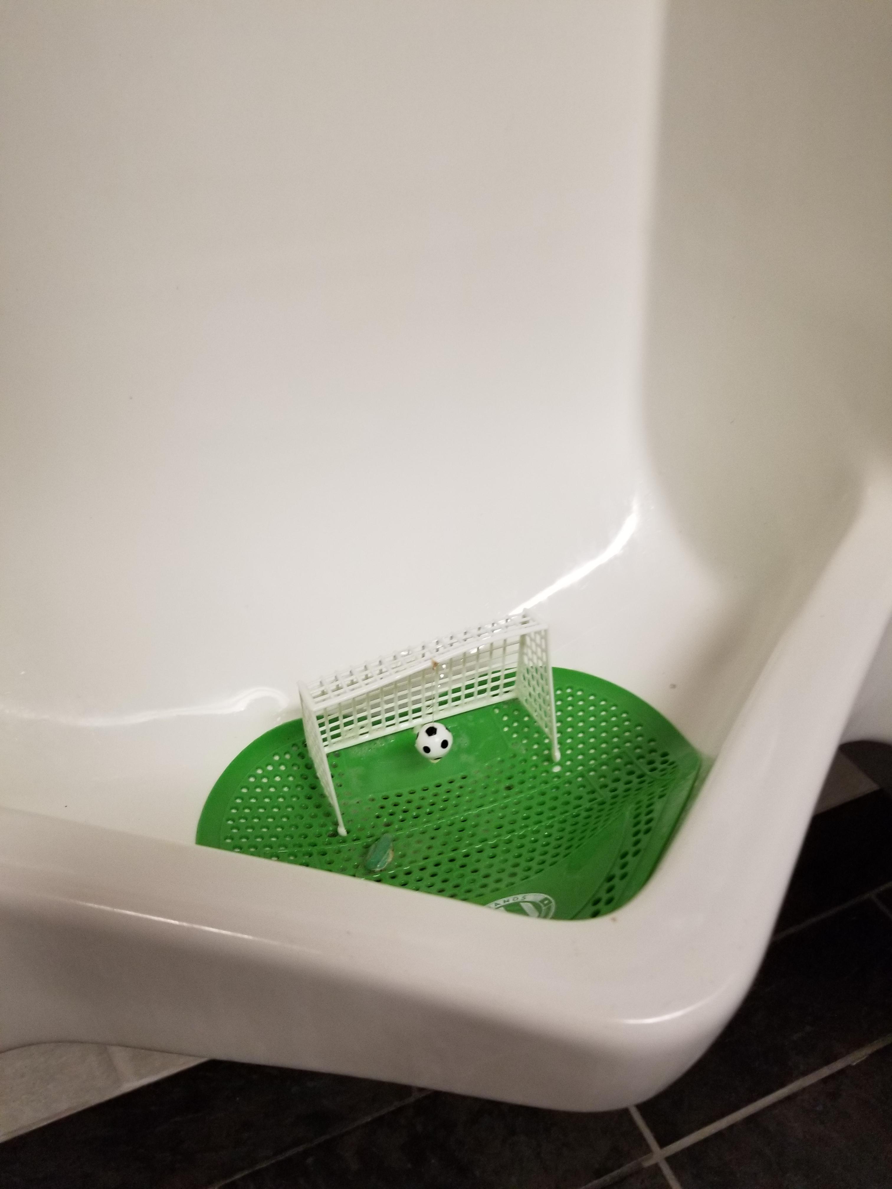 This mini soccer goal in a urinal to reduce splashback... r