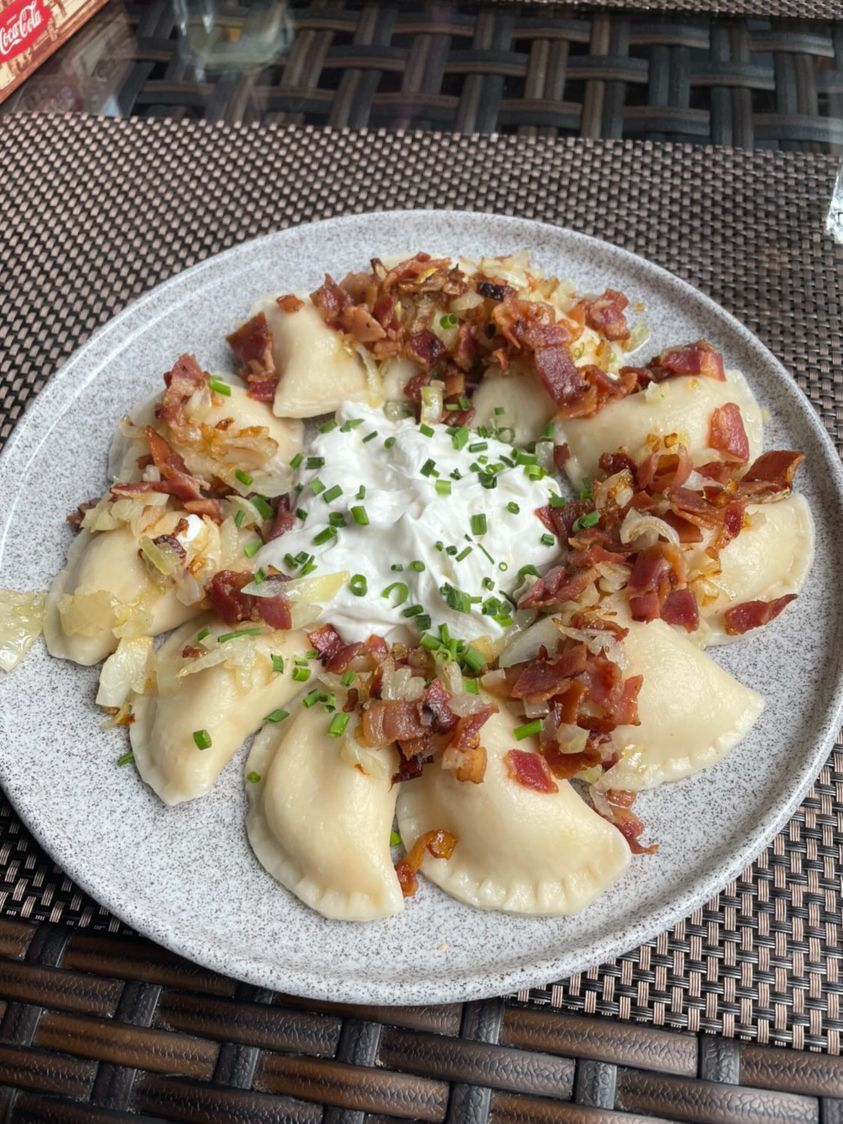 Pierogi filled with potatoes & Bryndza cheese, bacon, fried onion, sour
