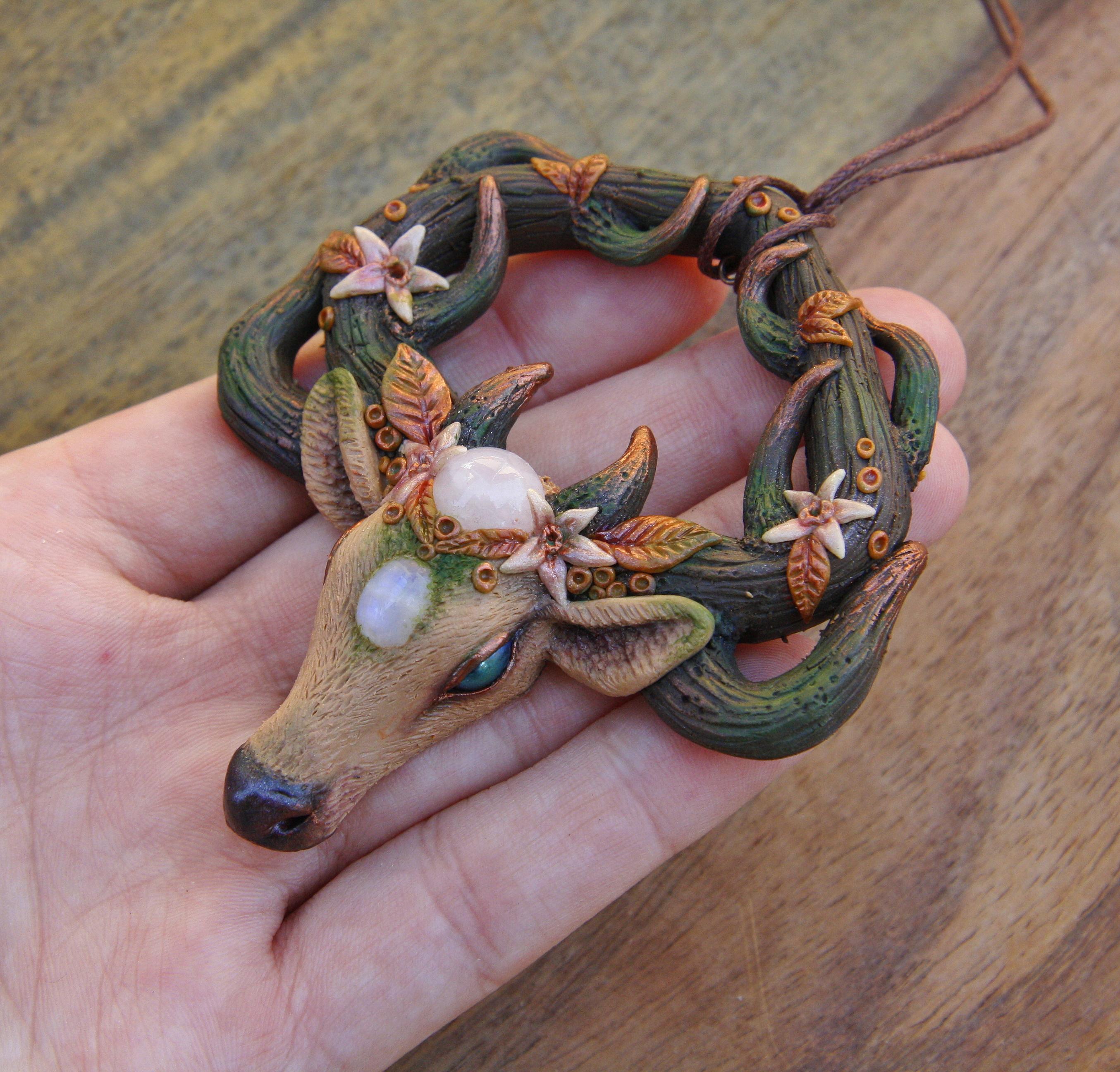 A handmade polymer clay deer pendant I made recently. It's decorated