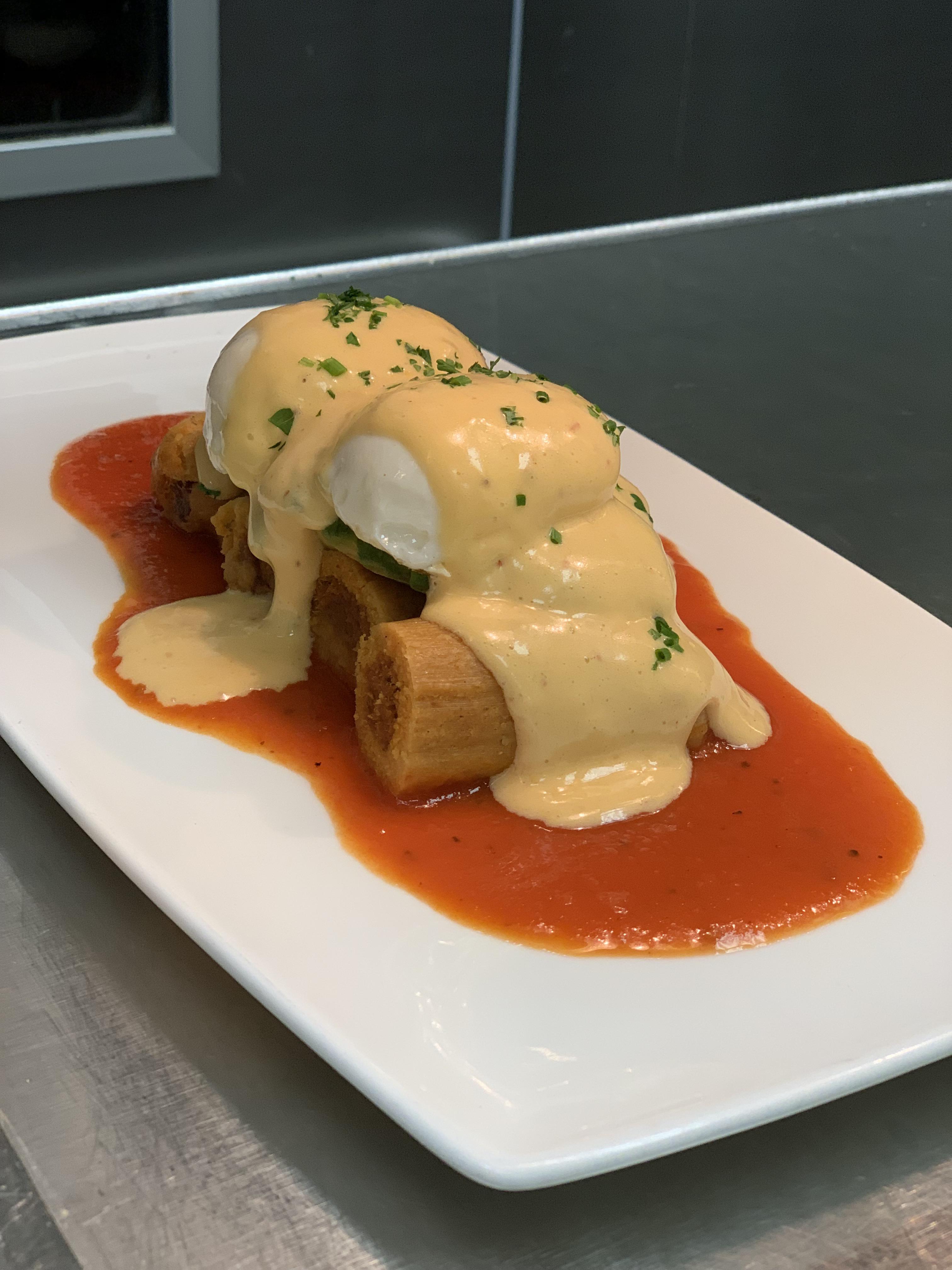 Tamale Benedict. Ancho pork tamales with ranchero sauce, avocado, 2 63