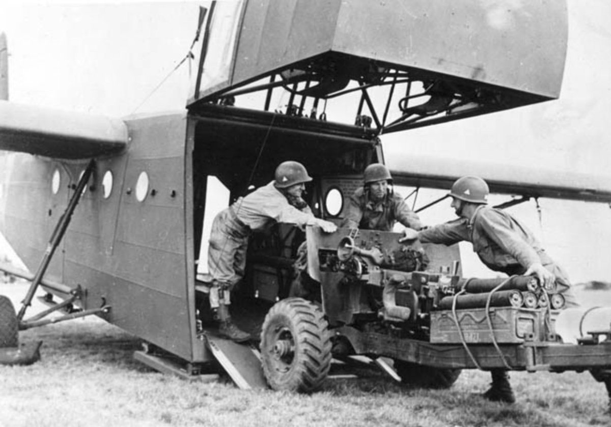 Paratroopers of the 82nd Airborne Division load an M1 57mm AntiTank Gun in to a glider shortly