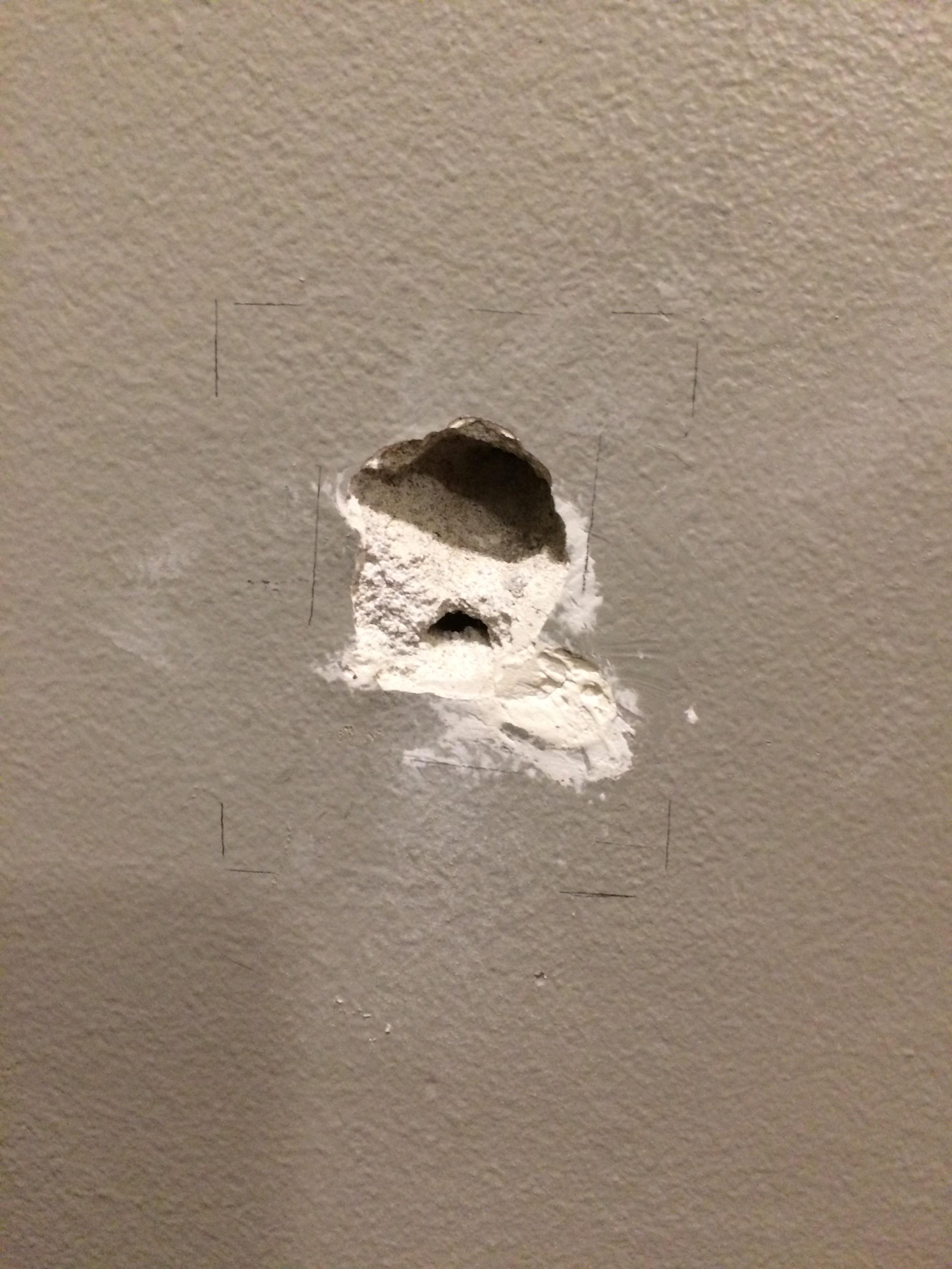 How do I fix this hole in the wall? It's on the wall that divides a