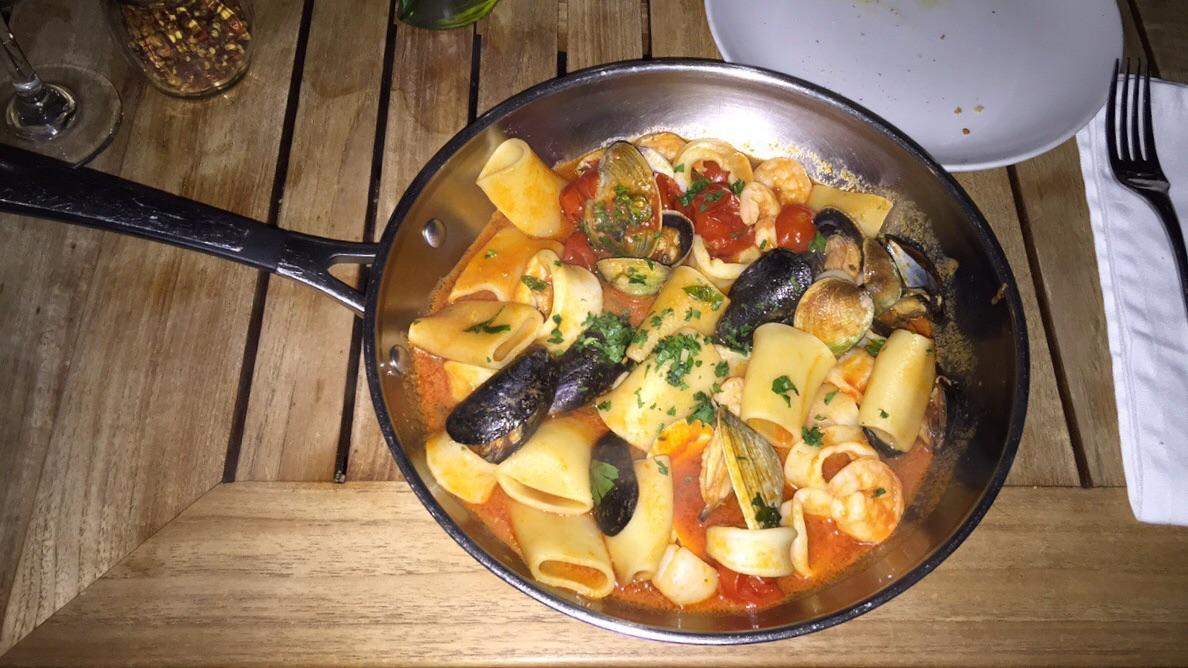 Paccheri ai Frutti di Mare served in a frying pan. WeWantPlates
