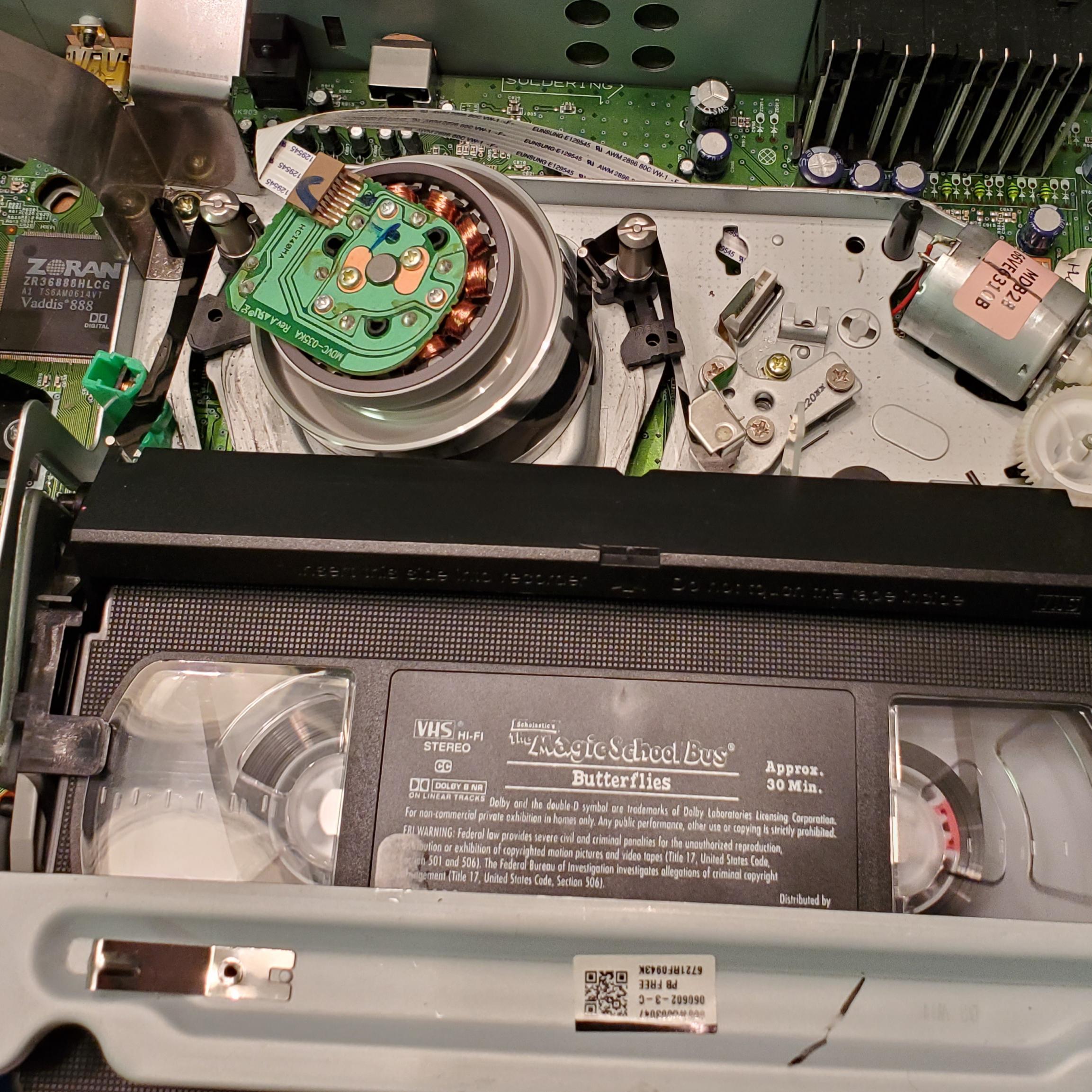 Internal workings of a VHS player. It pulls the tape out and wraps