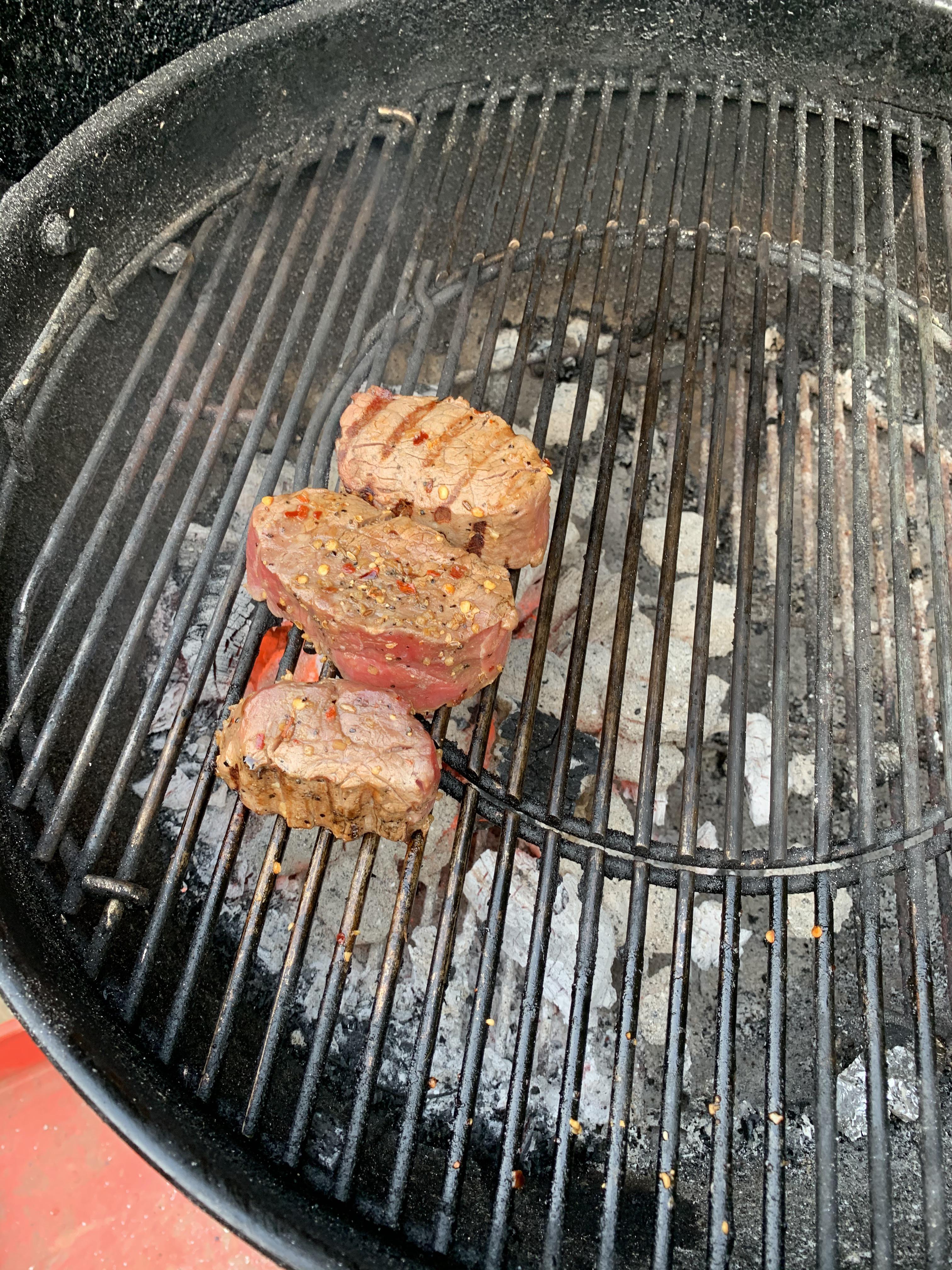 Beef tenderloin across lump charcoal. Marinated in chimichurri. Smells