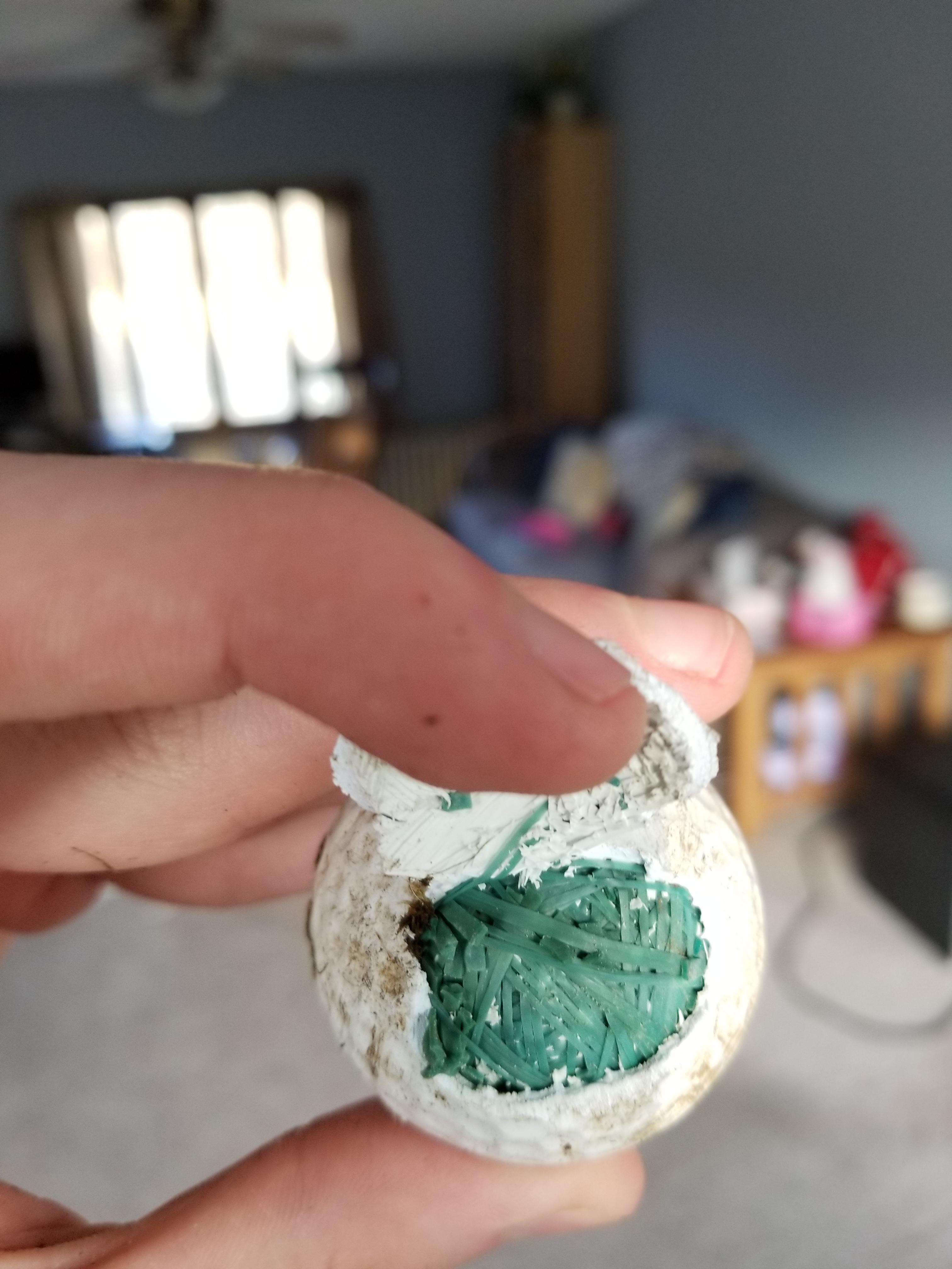 Hit a golf ball with my lawn mower a found a rubber band ball inside