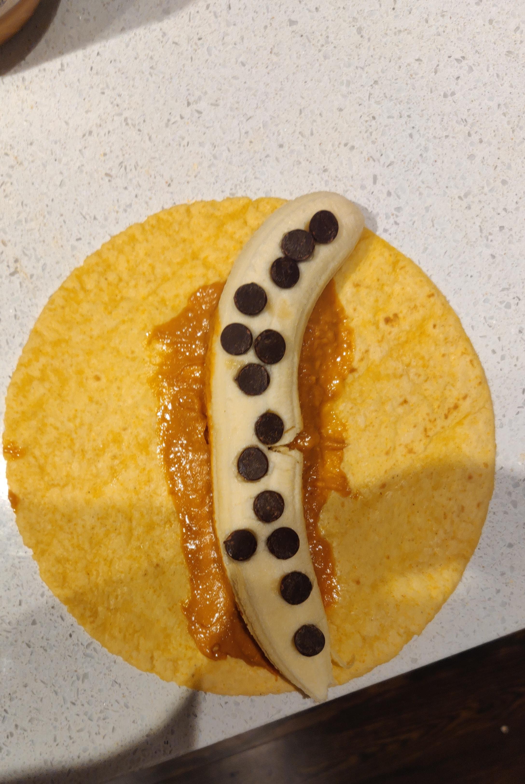 Leftover tortilla with a banana, peanut butter and chocolate chips r/ShittyVeganFoodPorn