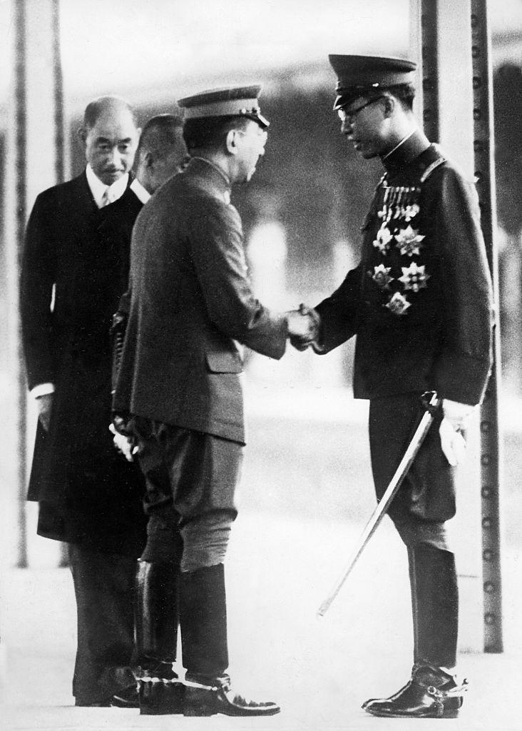 Japanese Emperor Hirohito shakes hands with KangTe (Pu Yi) Emperor of