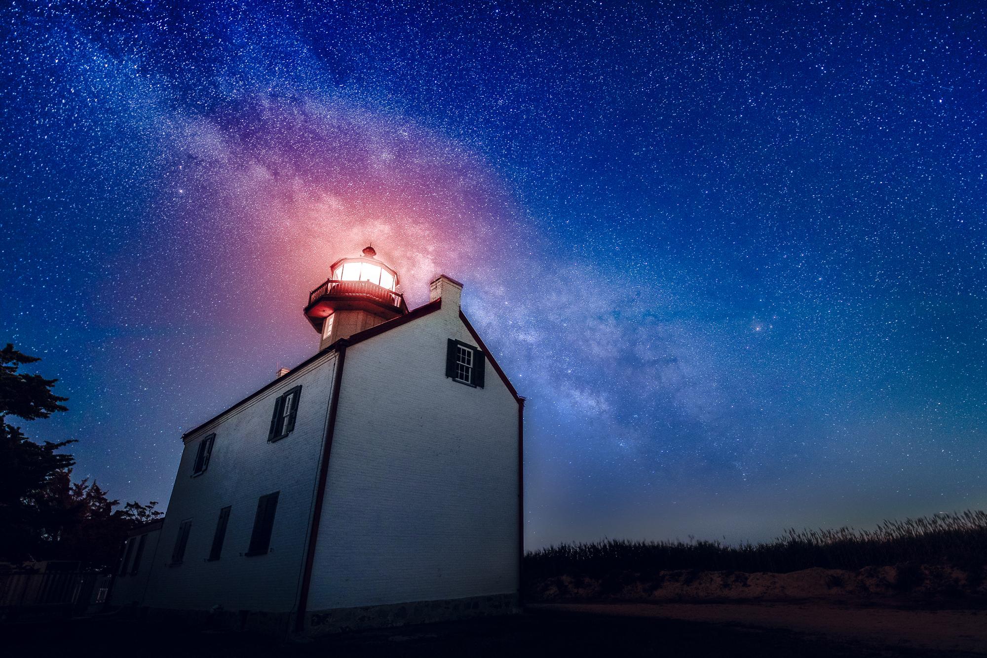 The galactic core of the Milky Way rises over East Point Lighthouse, NJ