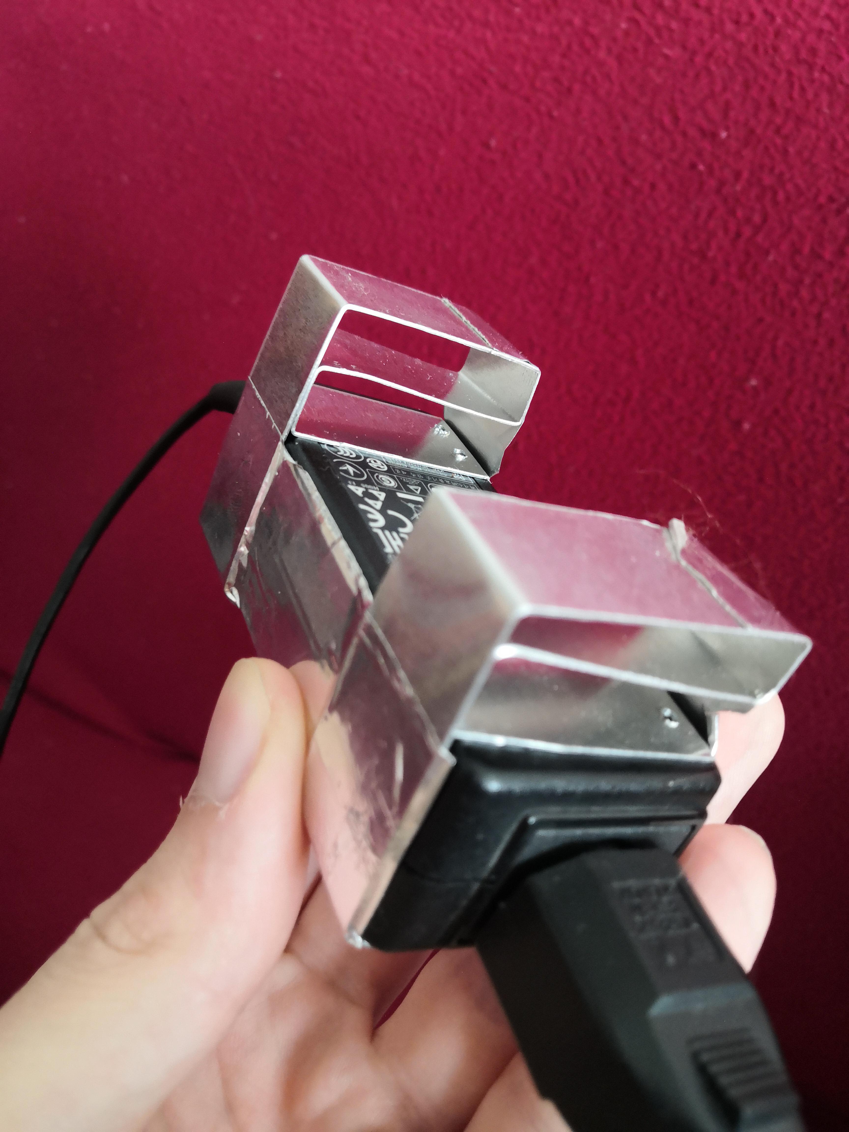 My laptop charger was overheating, so I fixed it with some aluminium scrap r/techsupportmacgyver