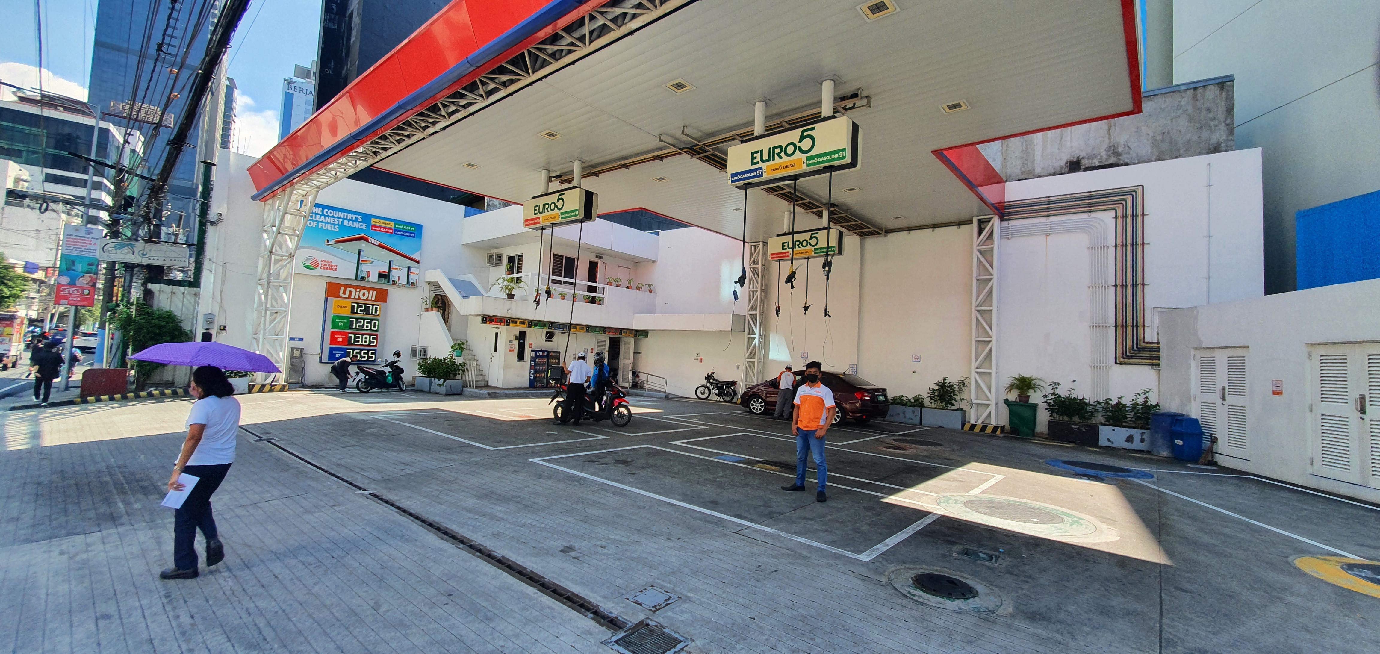 This gas station in Manila has no pumps on the ground the hoses lower