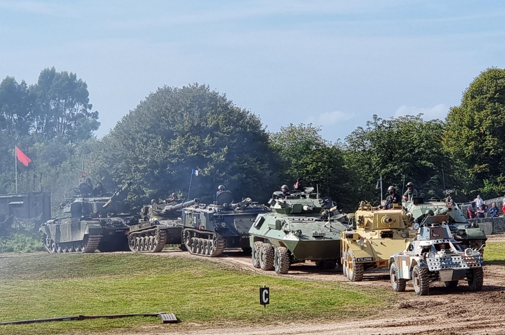 A queue of tanks with an APC and a challenger(?) hiding behind. r