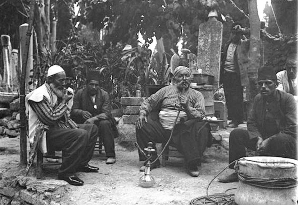 A group of men smoking a hookah in a cemetery, İstanbul 1910. r/hookah