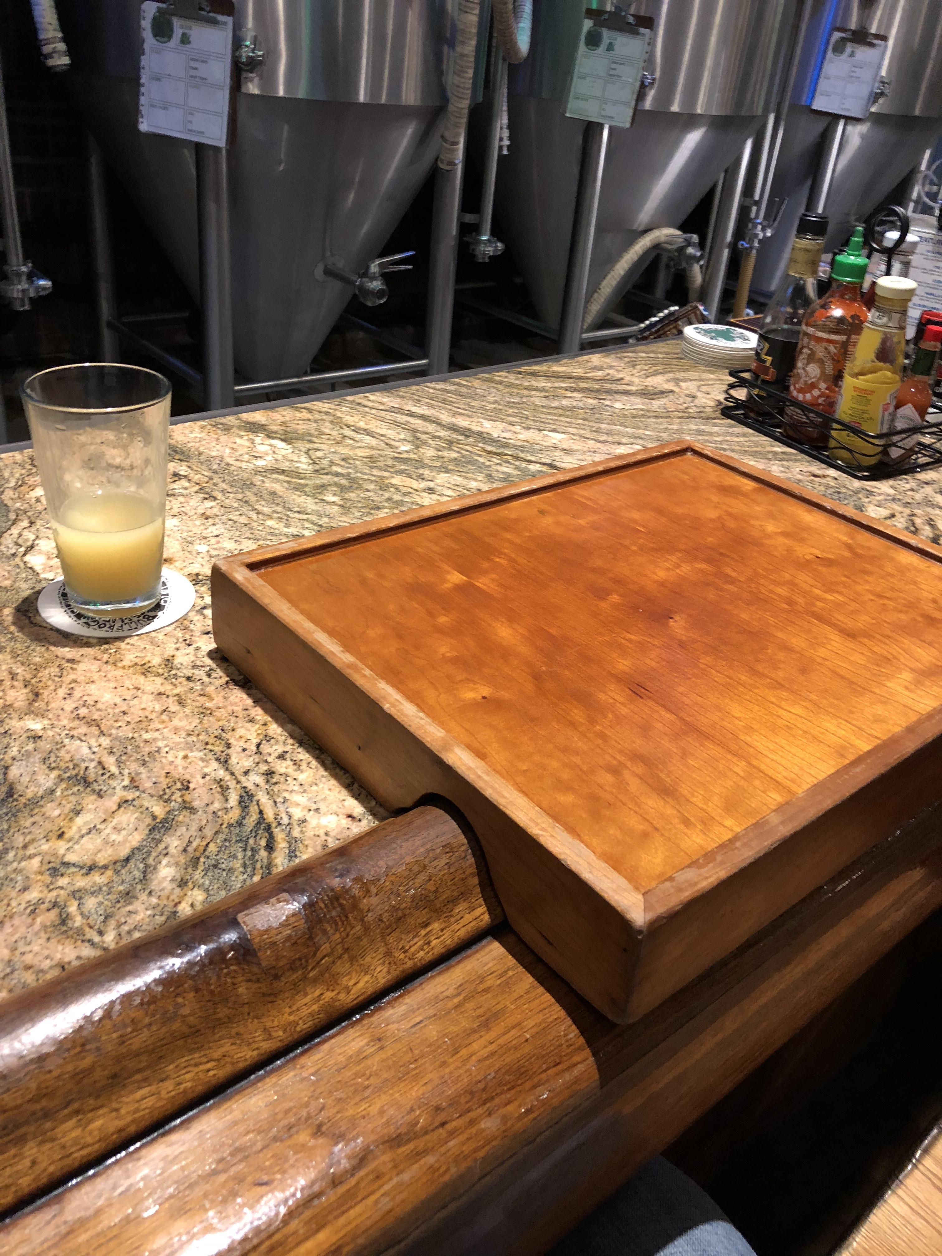 The bar I'm at gives you barfitting TV tray type things when you order food at the bar. r