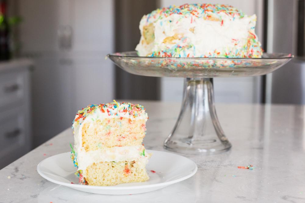 Birthday cake with 'sprinkles' and a white chocolate frosting! r