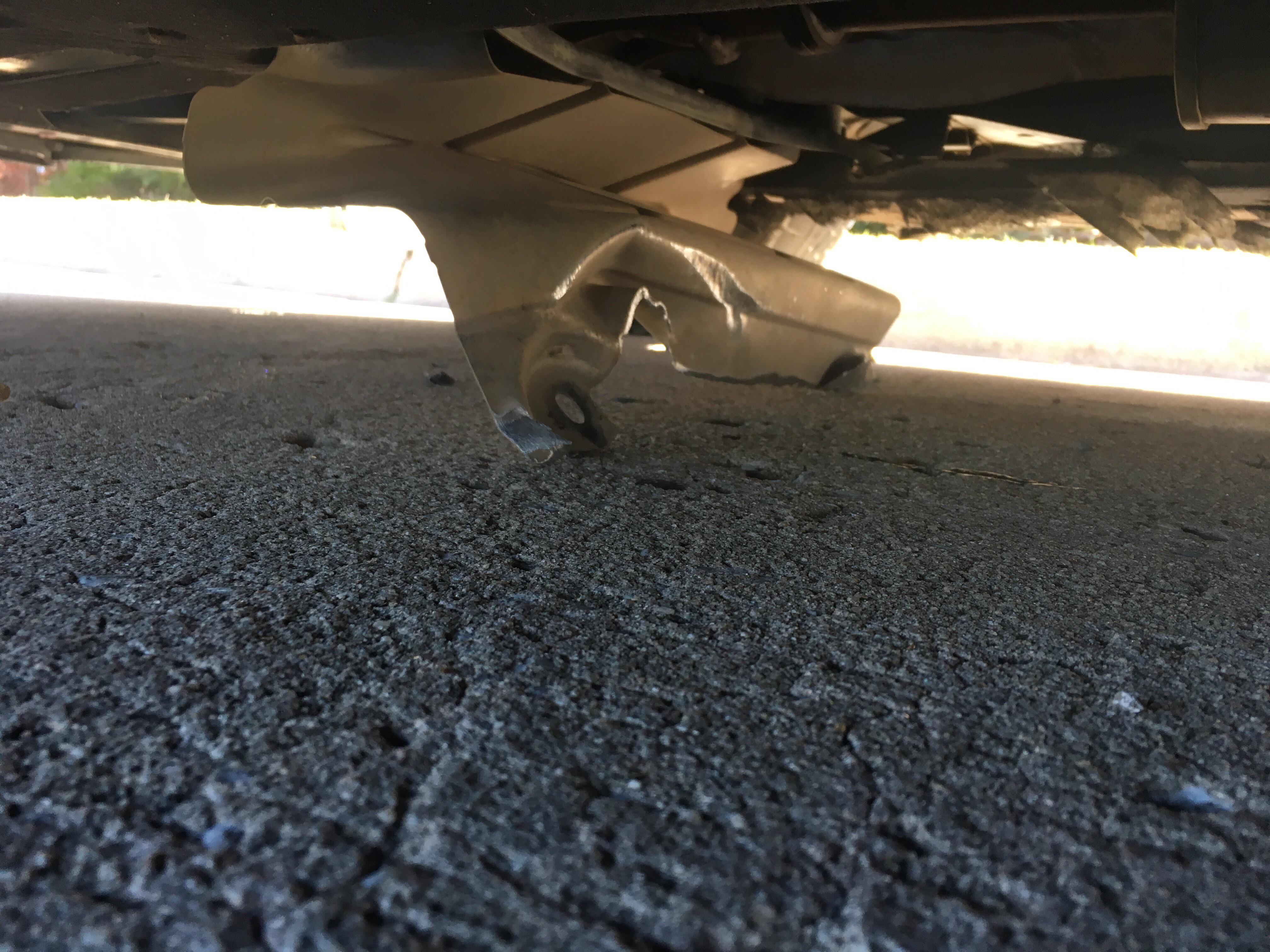 Piece of metal (heat shield?) bent under my car. I’m parked 2 miles