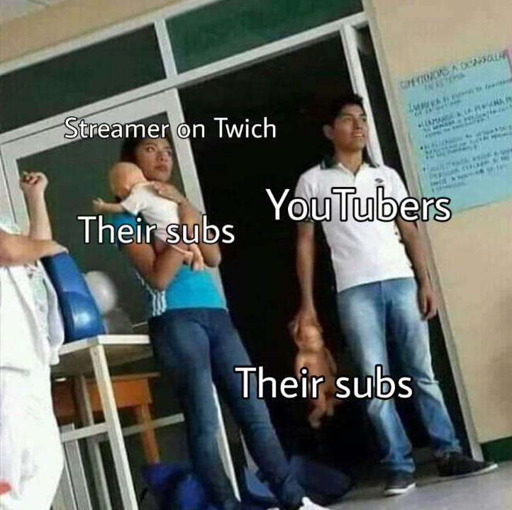 A woman holding a baby and a man holding a baby by the head r