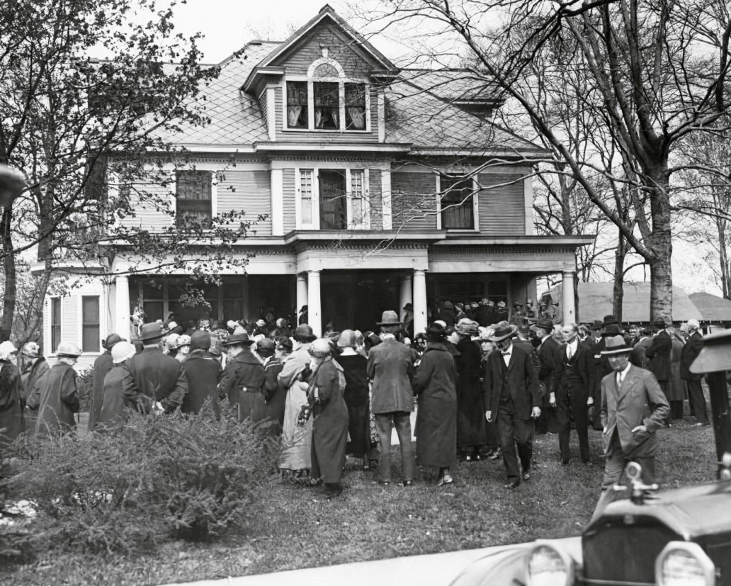 Mourners gather outside the home of Madge Oberholtzer, a white American
