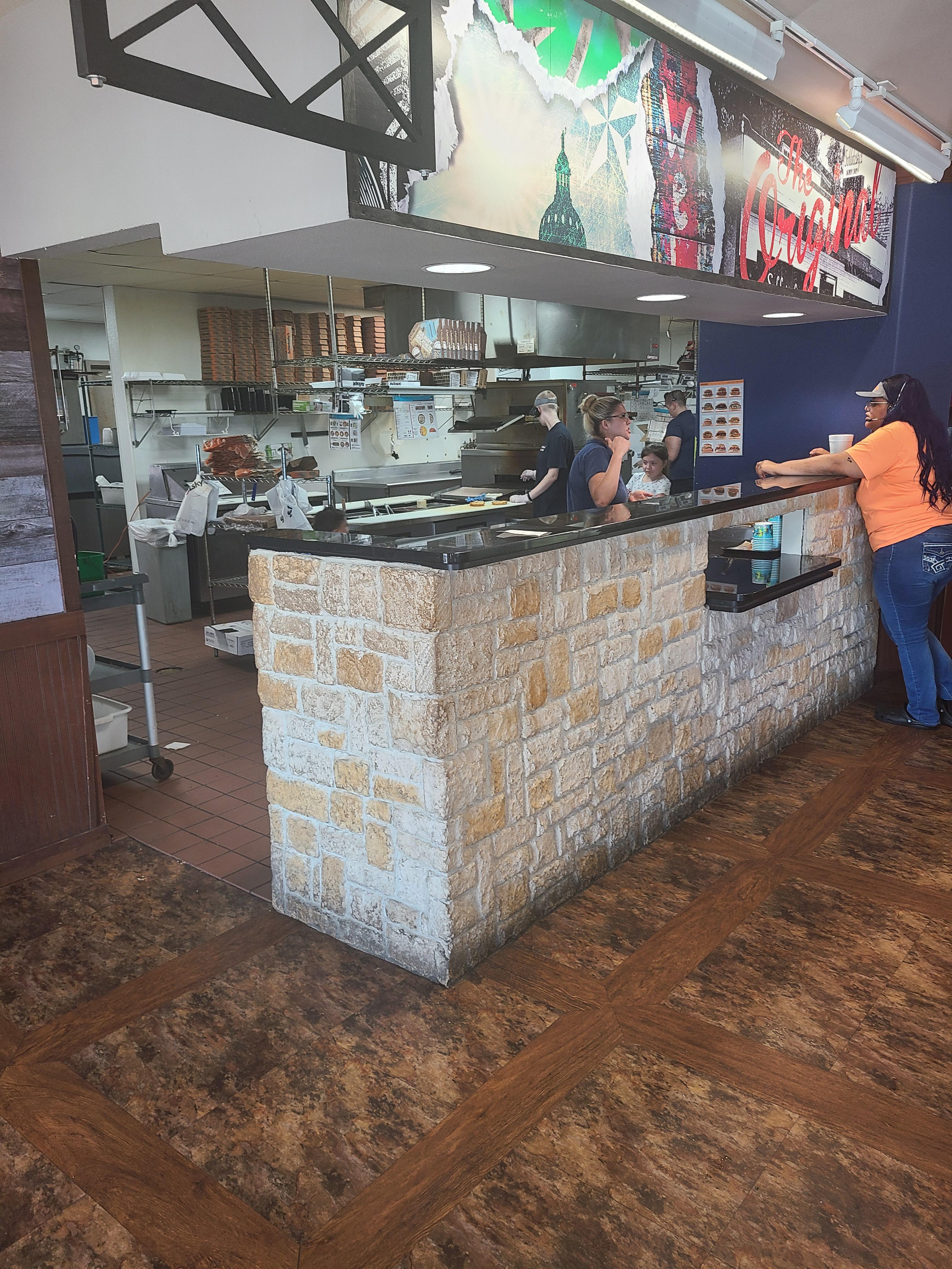 Schlotzsky's has kid working in the kitchen delivering food r