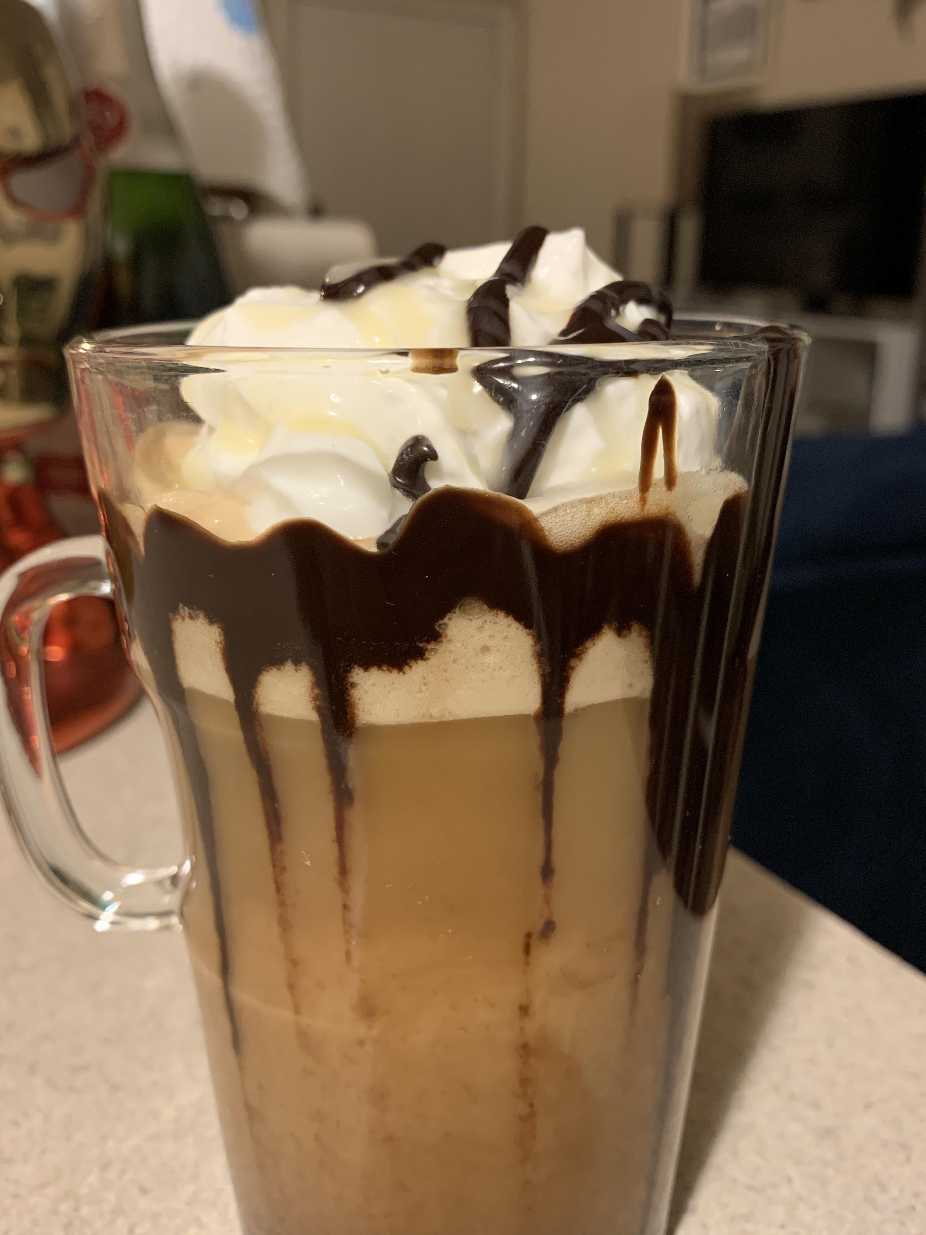 Cocoa truffle with a little chocolate syrup art, whipped cream & almond