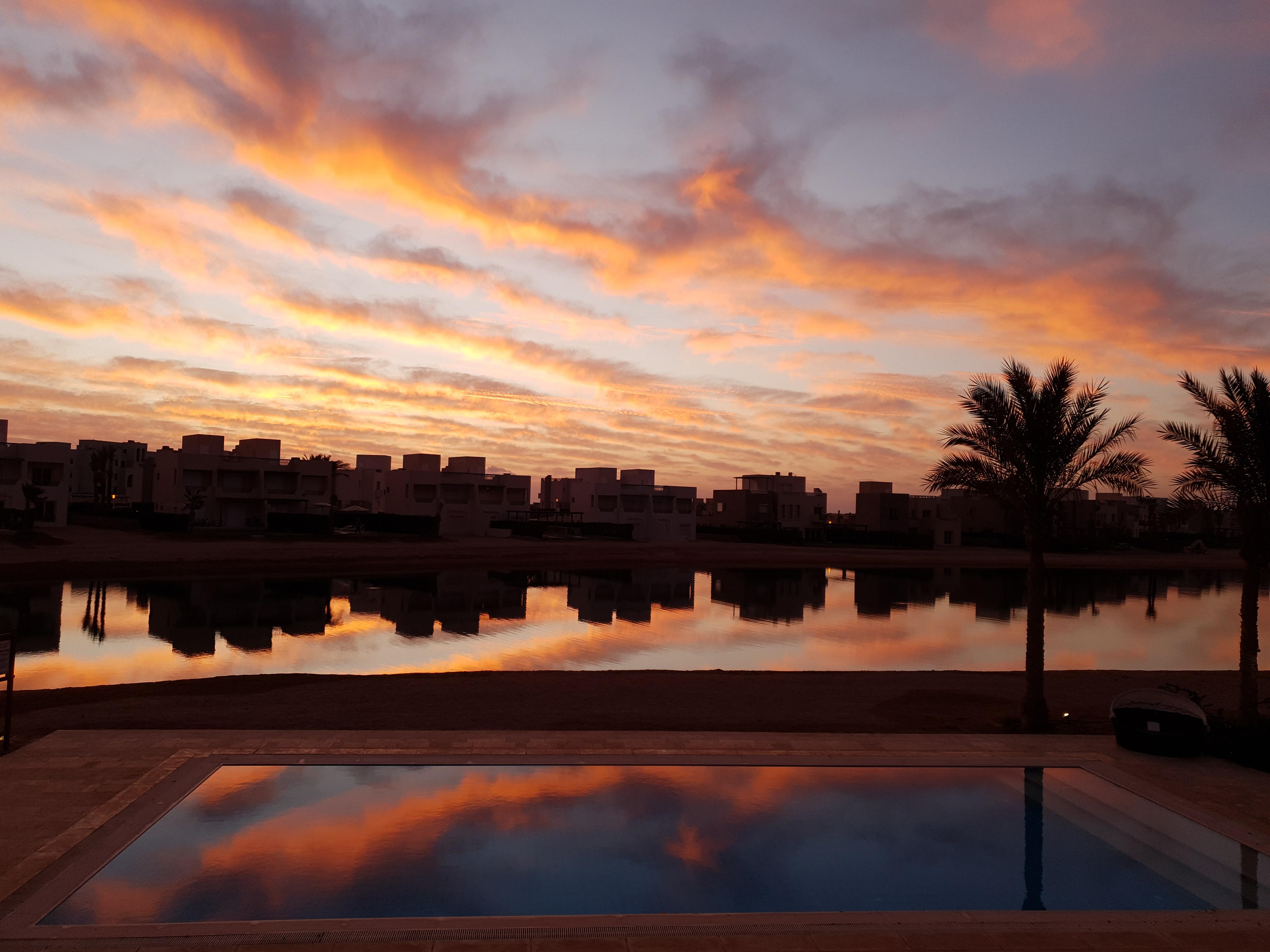 Sunrise reflection off the pool and lagoon from an Airbnb in El Gouna