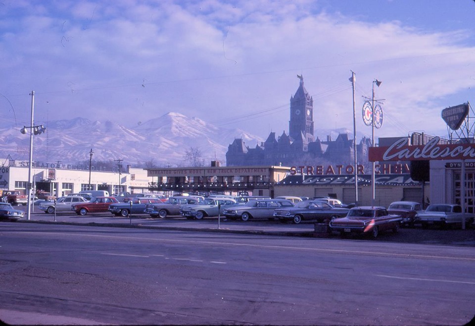 Downtown car lot in the 1960s, neat view of the City & County Building