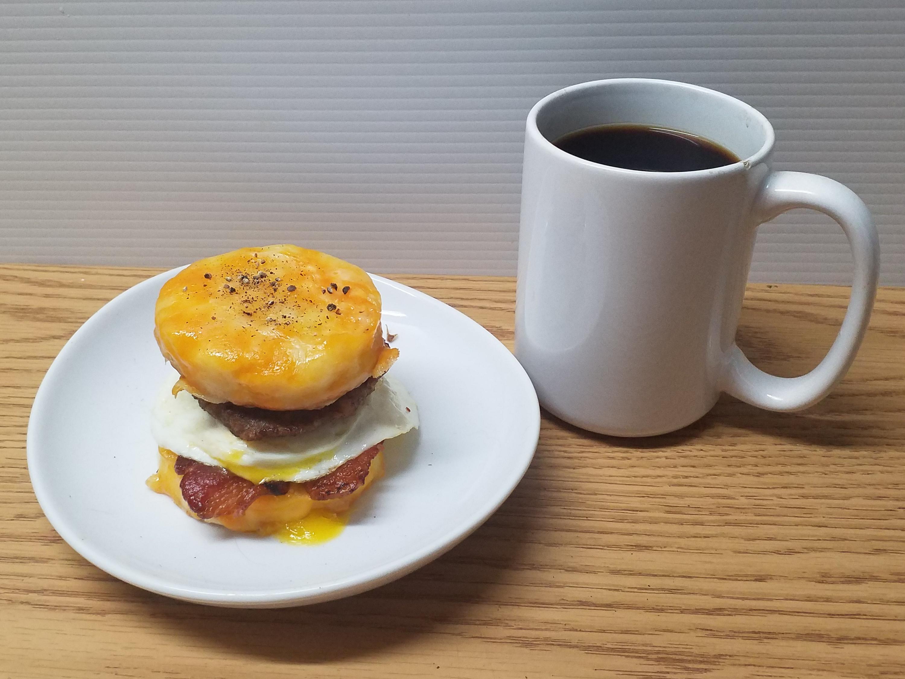 Bacon Sausage Egg and Triple Colby Cheese on a Buttermilk Biscuit with