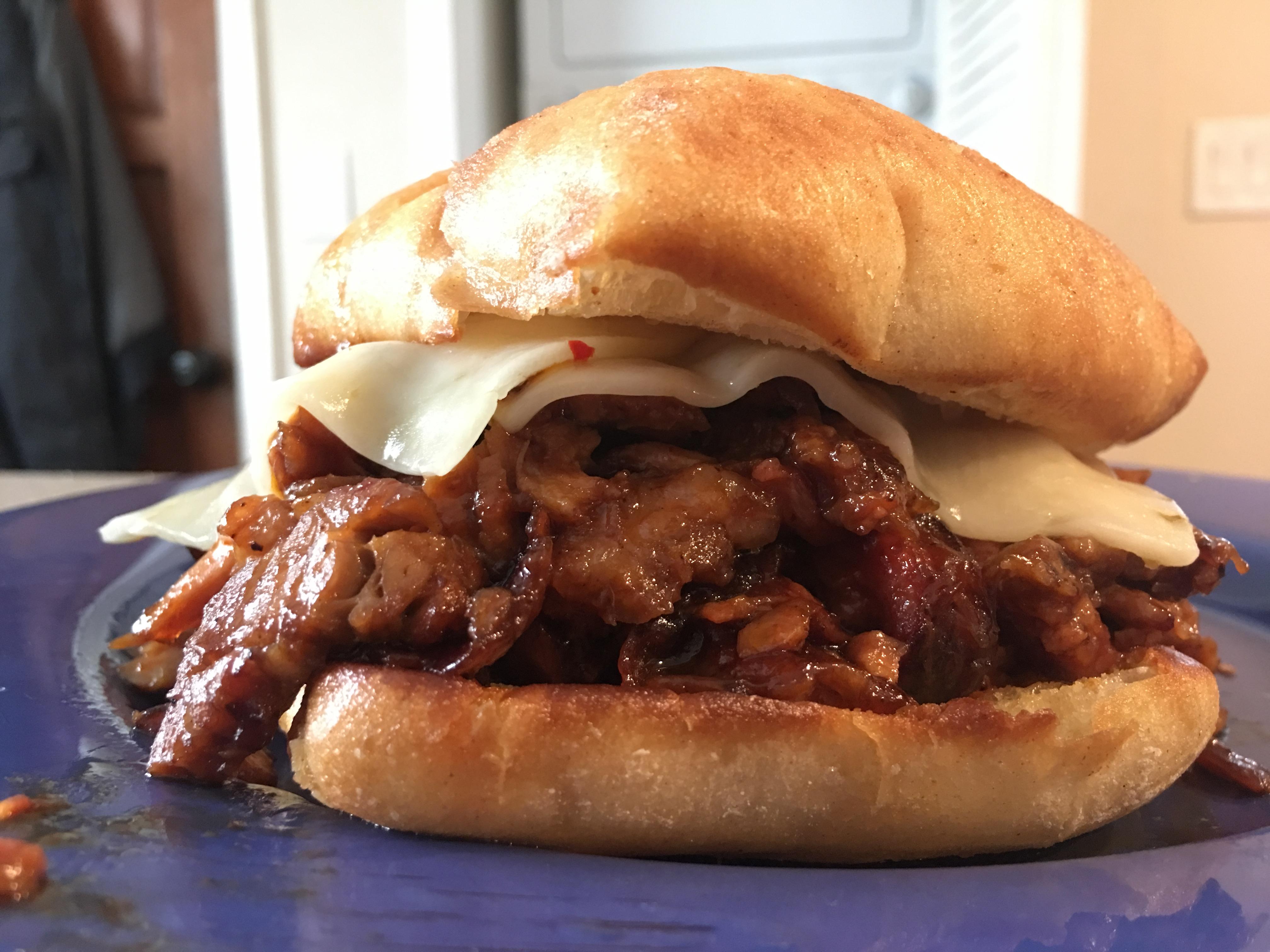 [homemade] smoked brisket, chicken, and rib sandwich on a ciabatta roll