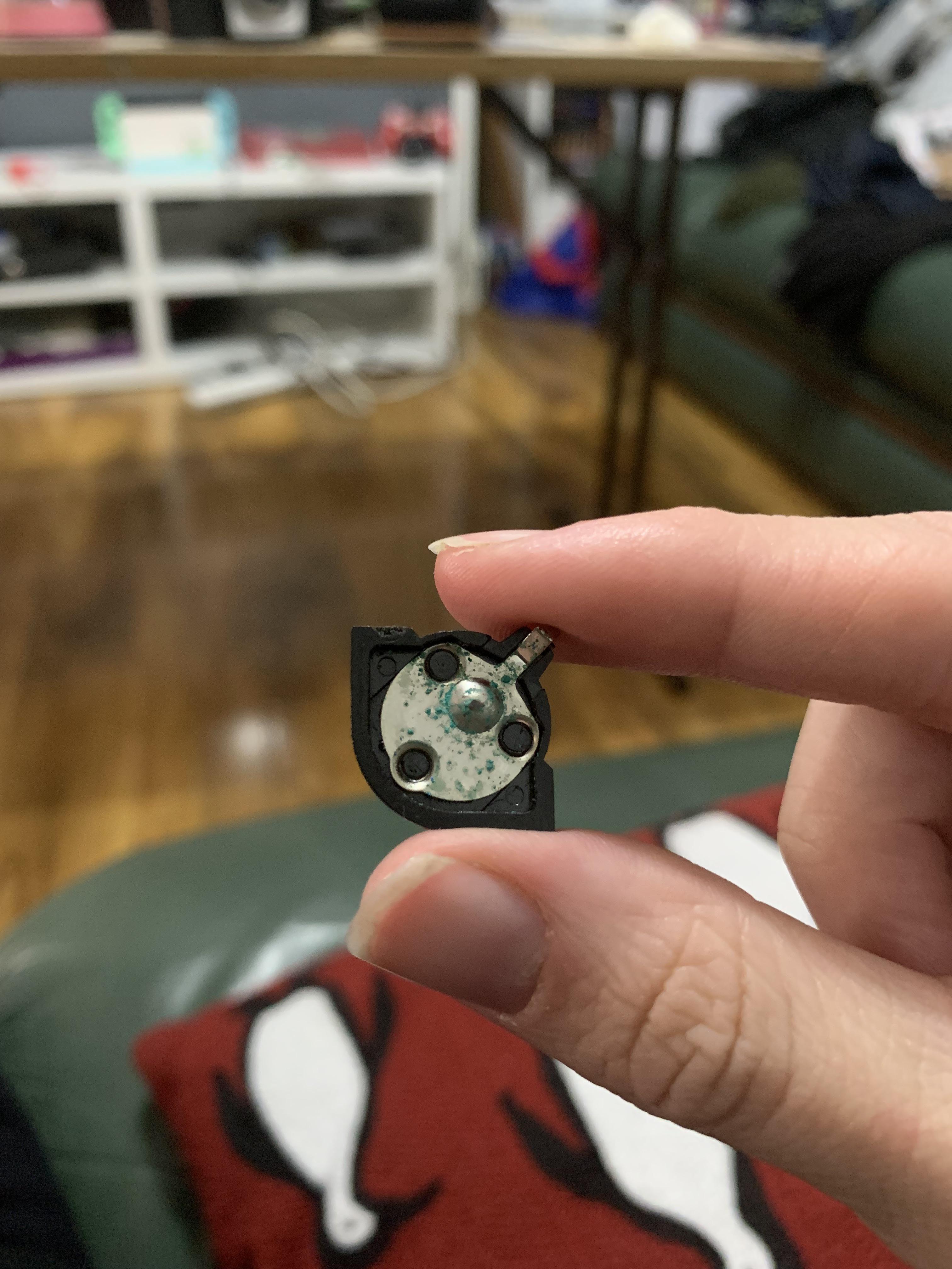 Battery top corrosion on Olympus XA2 A11 flash, how should I go about