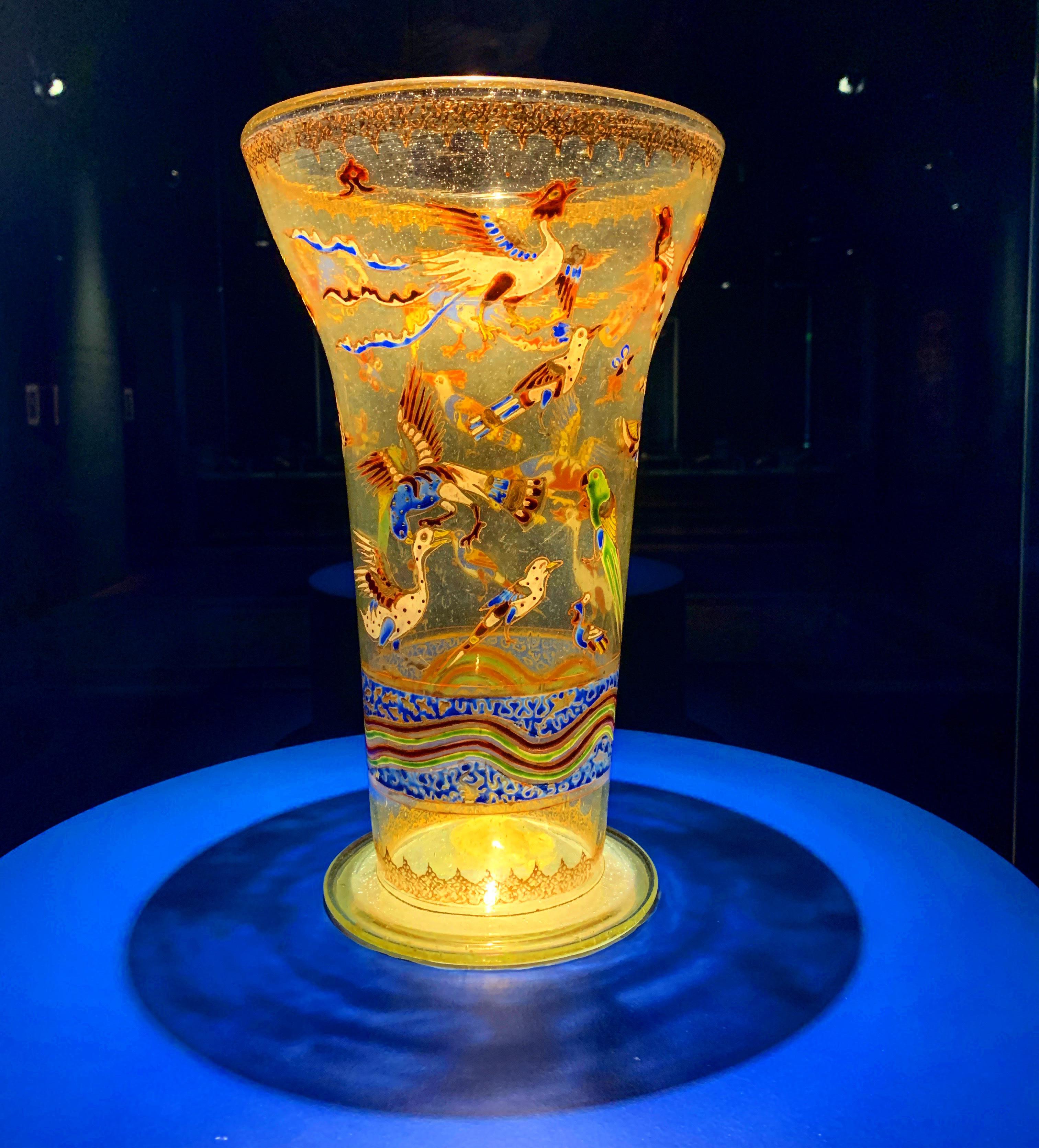A Mamluk enamelled and gilded glass beaker decorated with mythical and real birds. Made in Egypt
