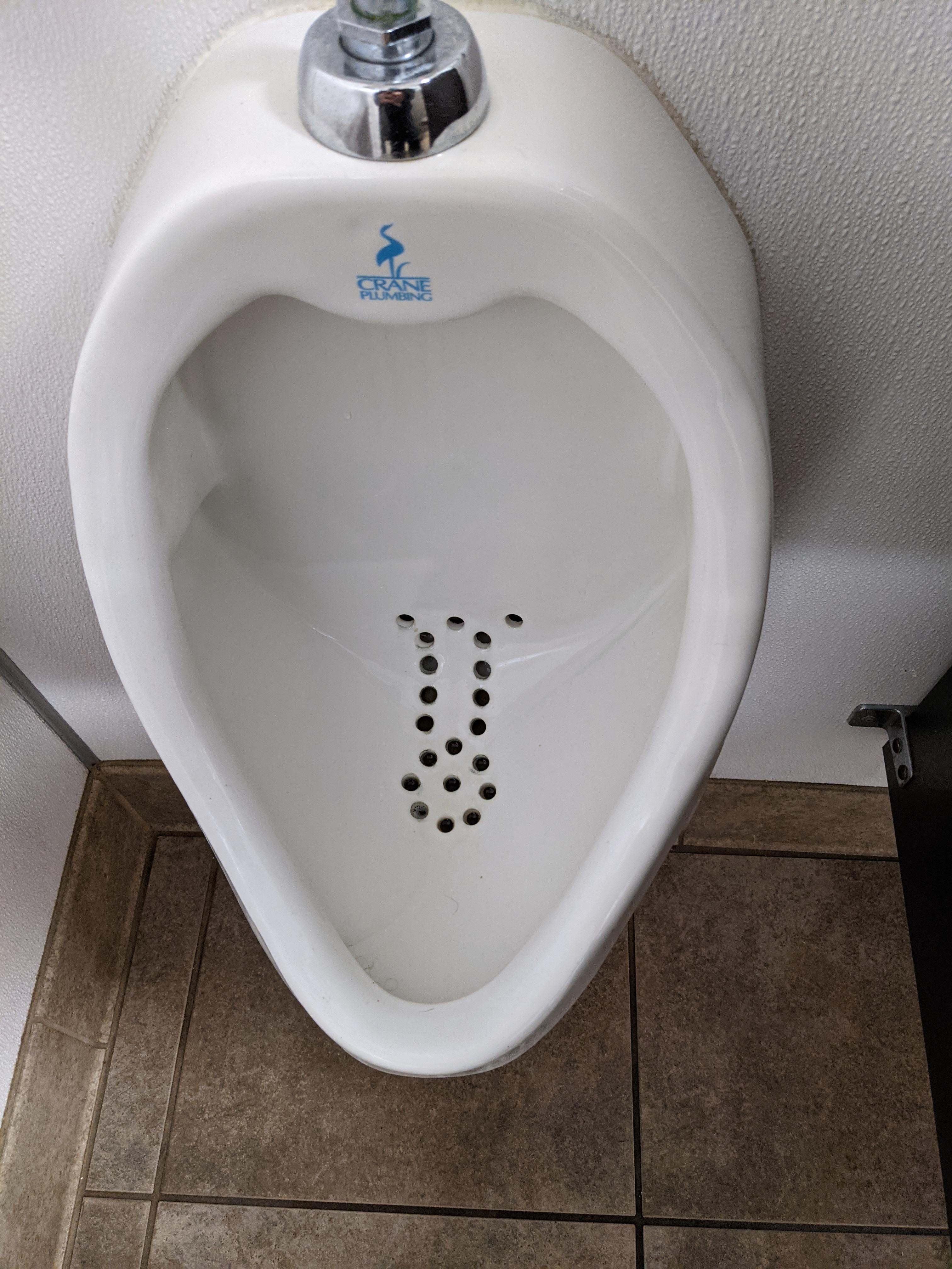 The drain holes on this urinal are strategically placed. r