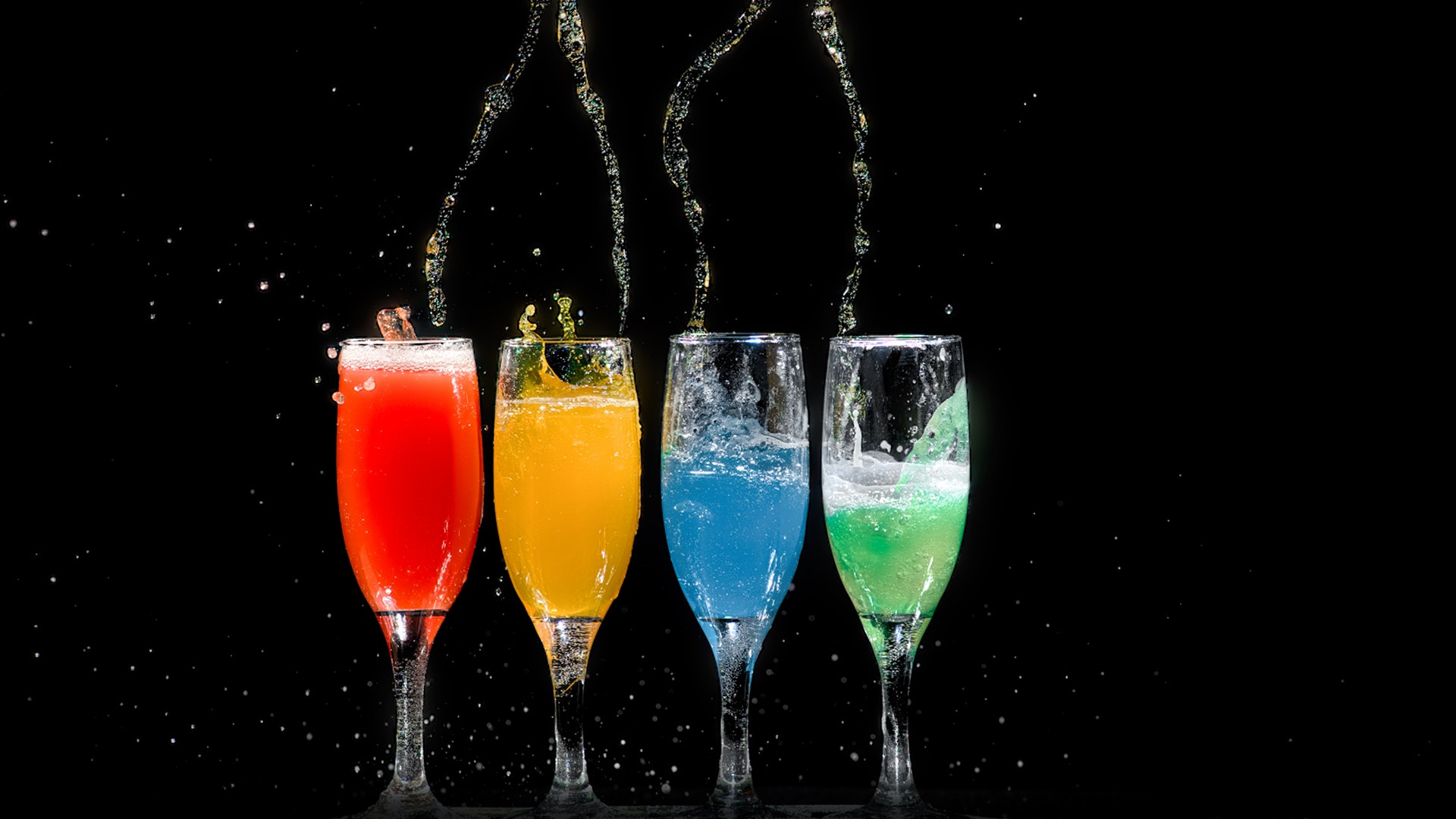 Four Champagne Flutes With Assorted Color Liquids [1920 x 1080] r