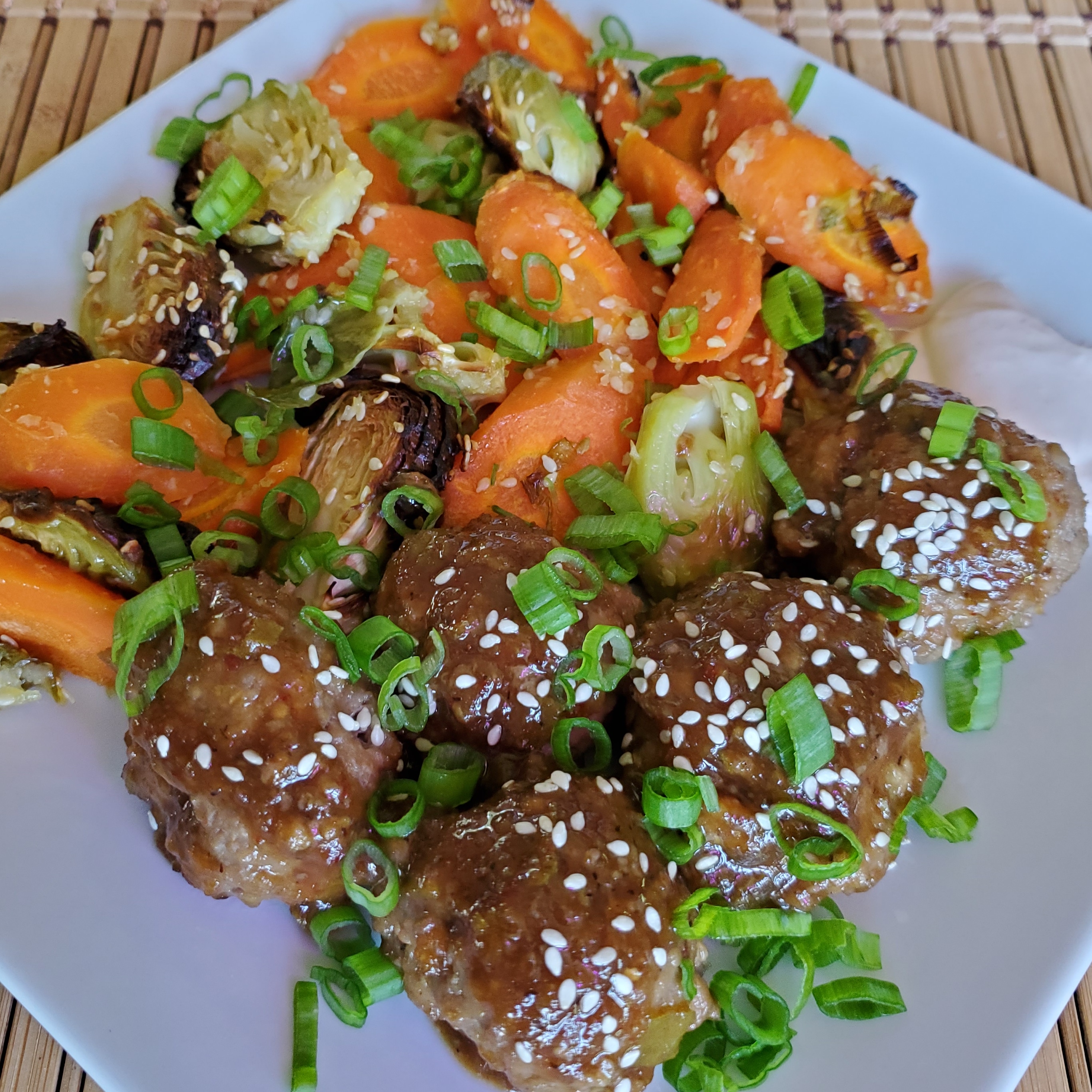 Beef bulgogi meatballs with roasted ginger carrots, brussel sprouts and