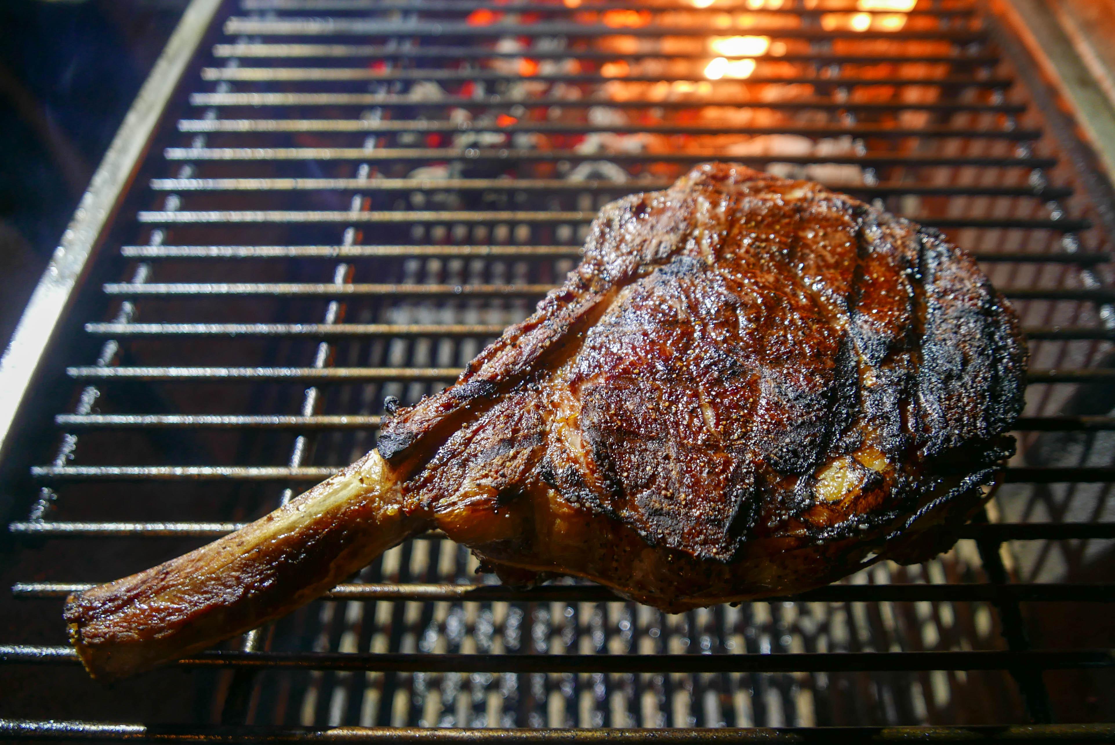 Tomahawk Steak about to come off the grill after being seared, then