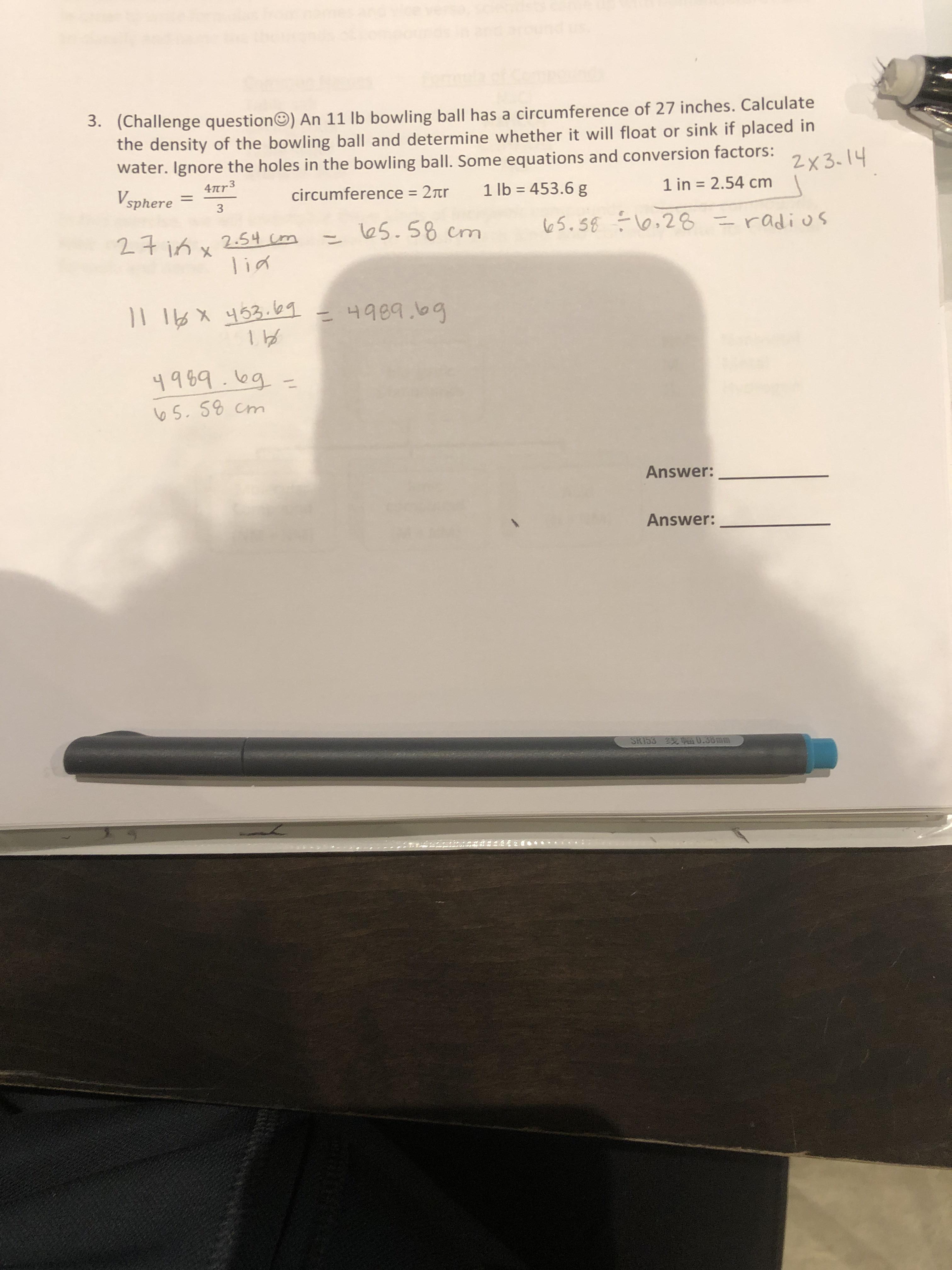 An 11 lb bowling ball has a circumference of 27 inches. Calculate the