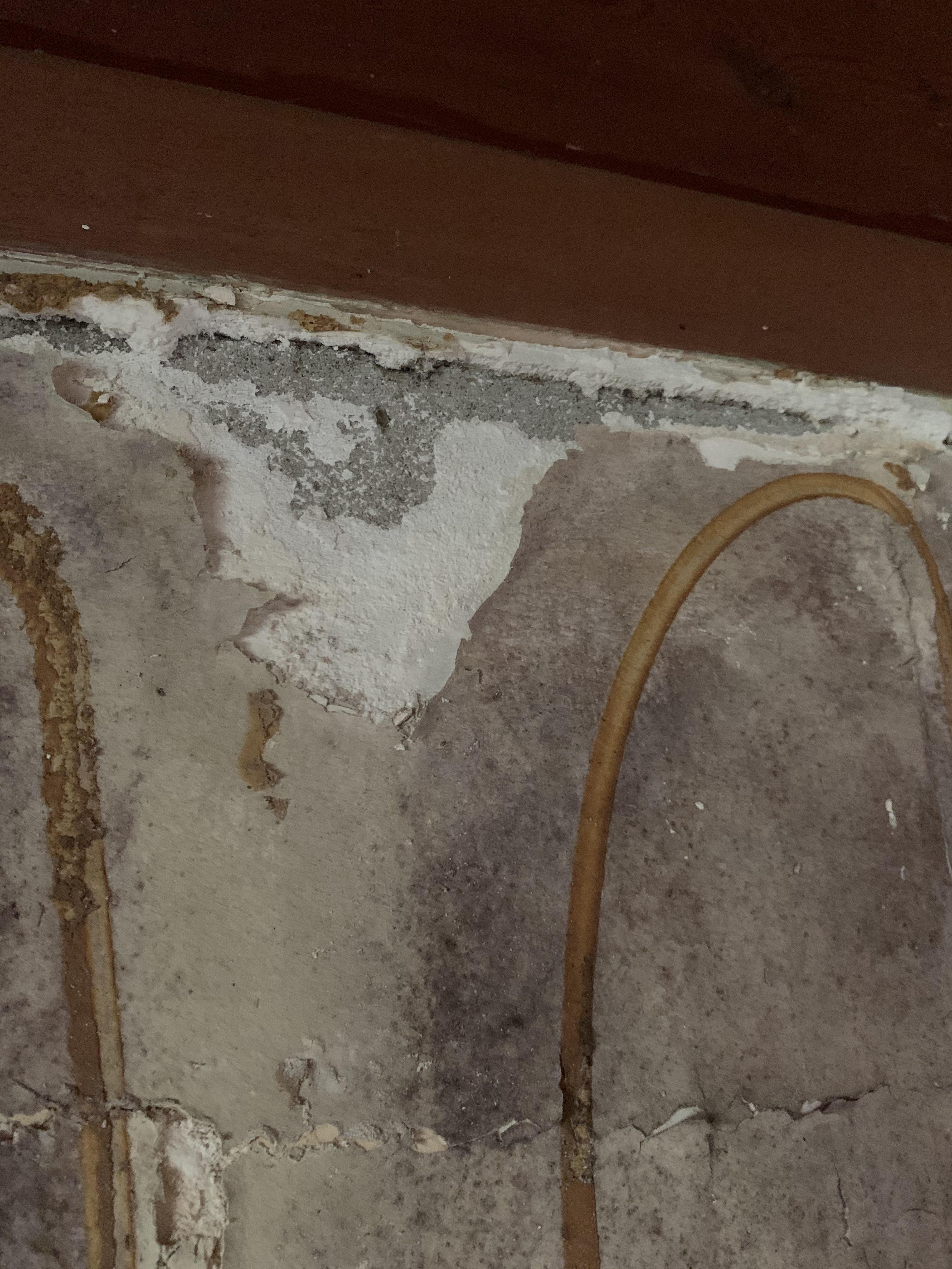 There’s this drywall like material over the concrete block wall in my
