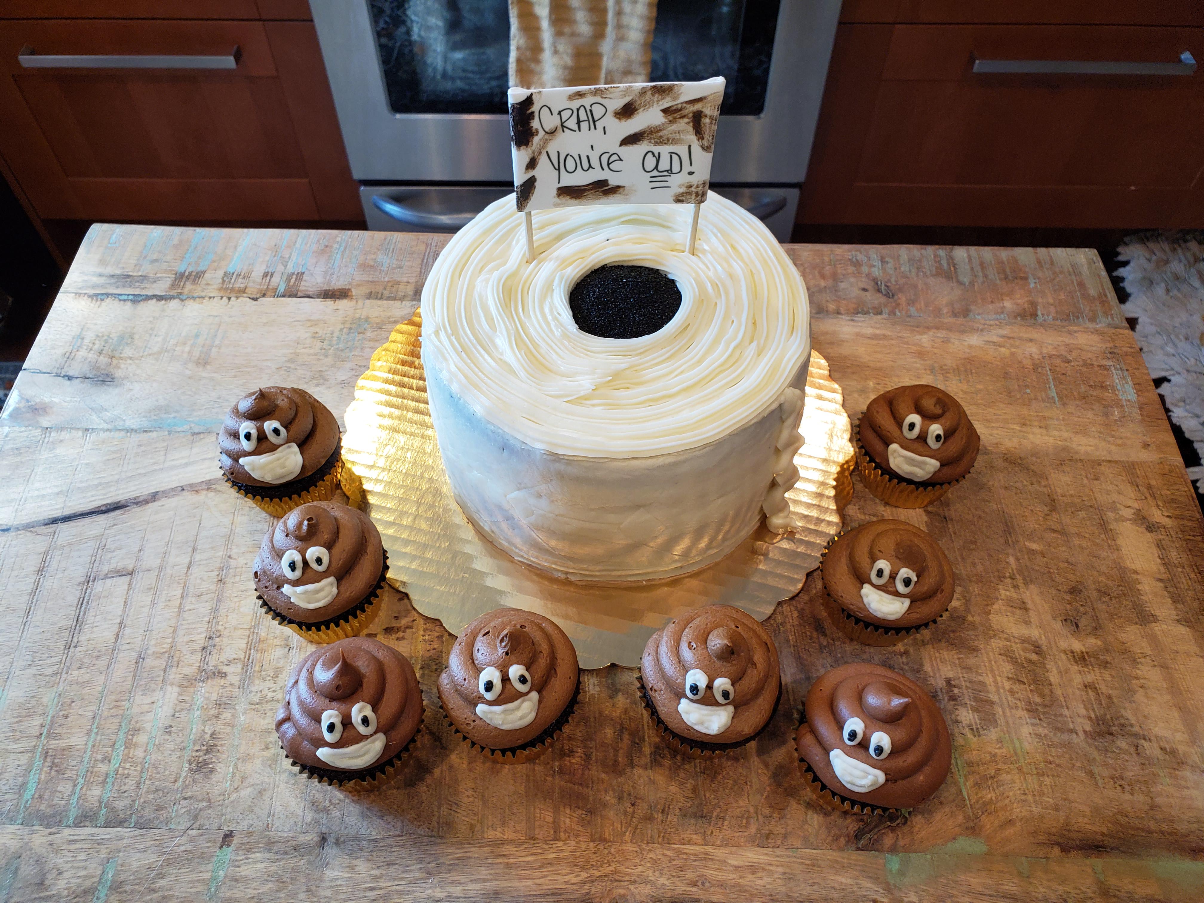 Chocolate toilet paper cake with "poop" cupcakes! Cream cheese frosting