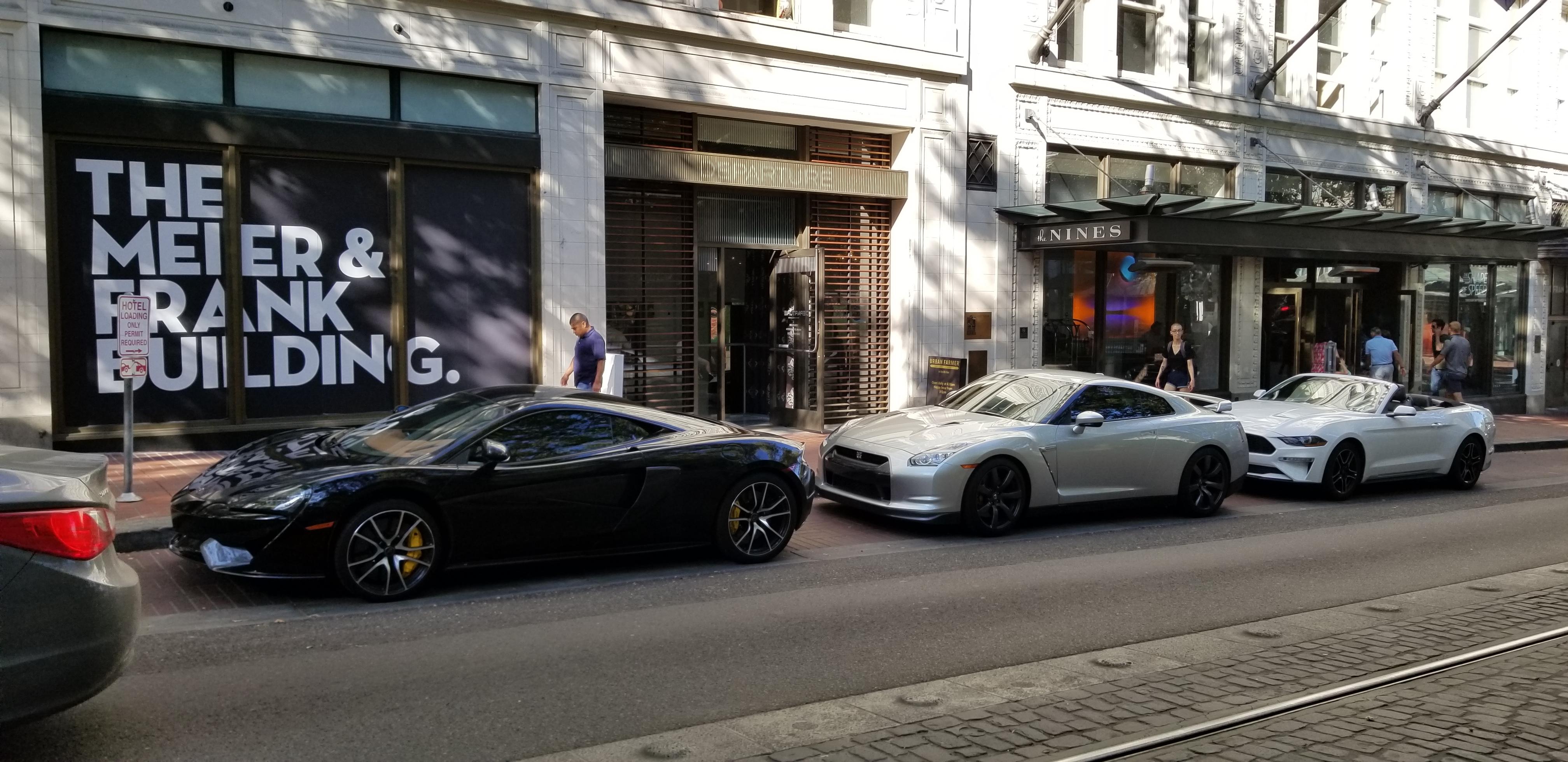 Beautiful trio of cars in downtown Portland, parked in the proper order