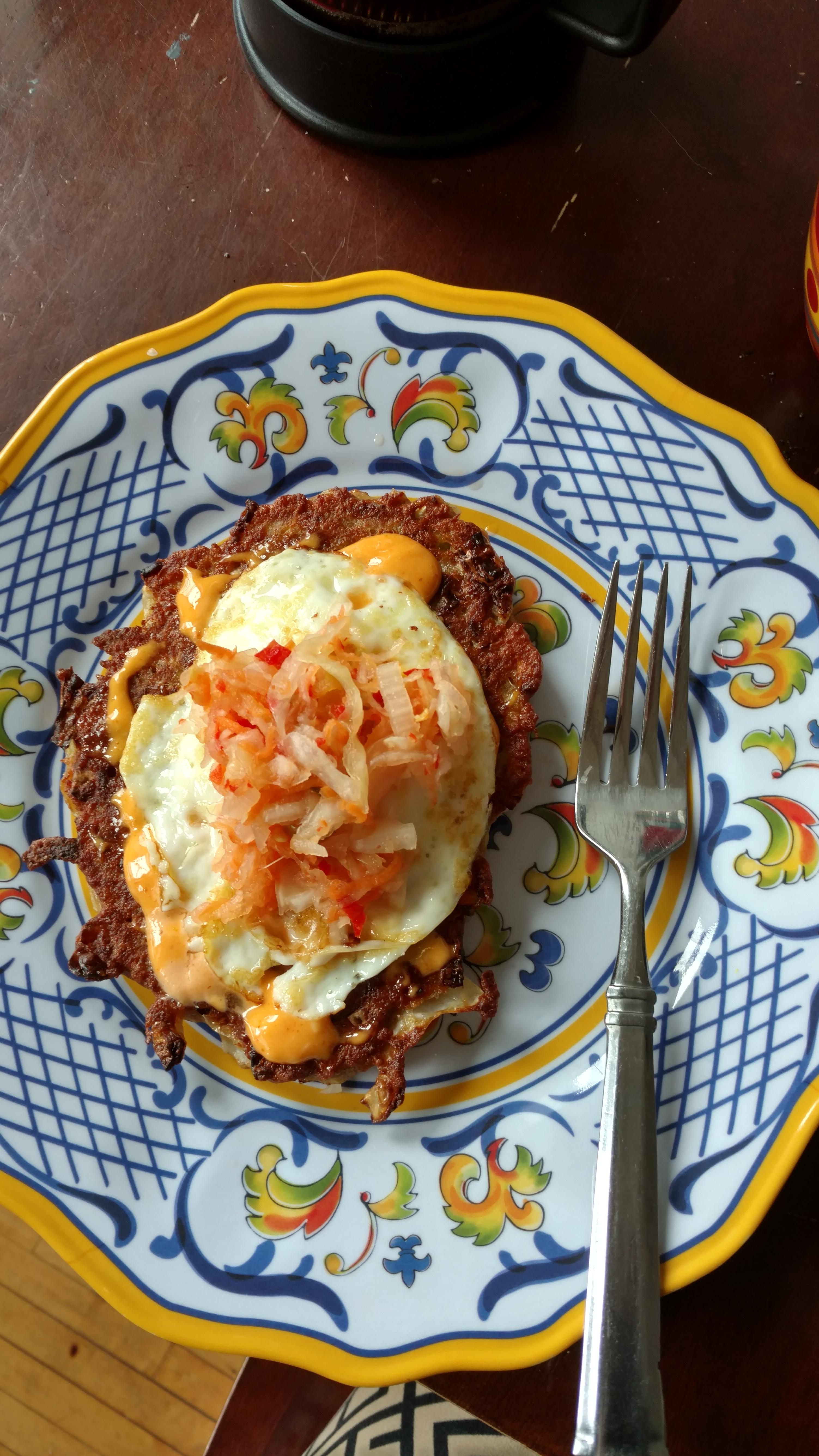 Cabbage cakes topped with a runny egg, Sriracha mayo, and spicy kimchi