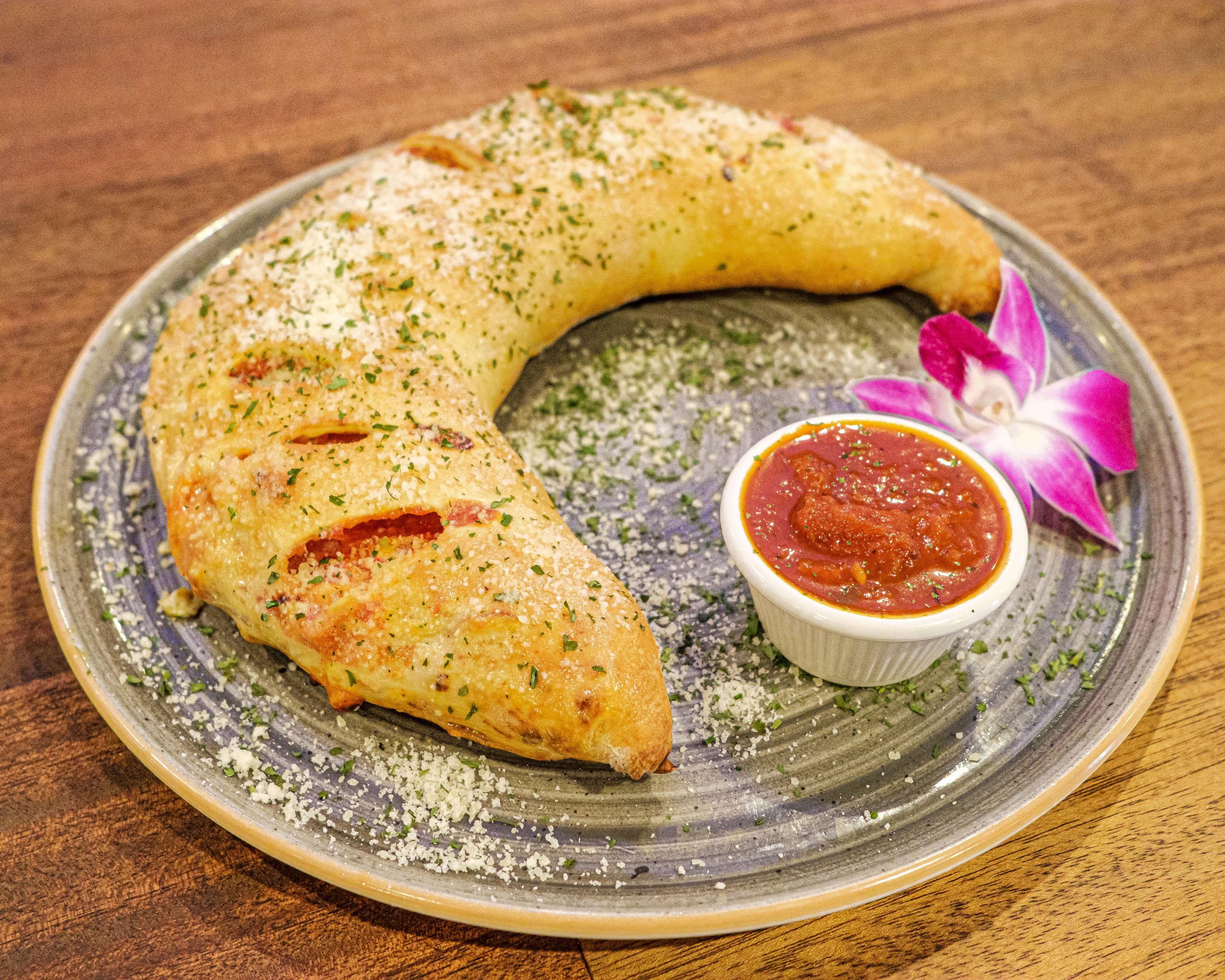 Gramci's Calzone with ham, salami, pepperoni, lots of cheese, ricotta