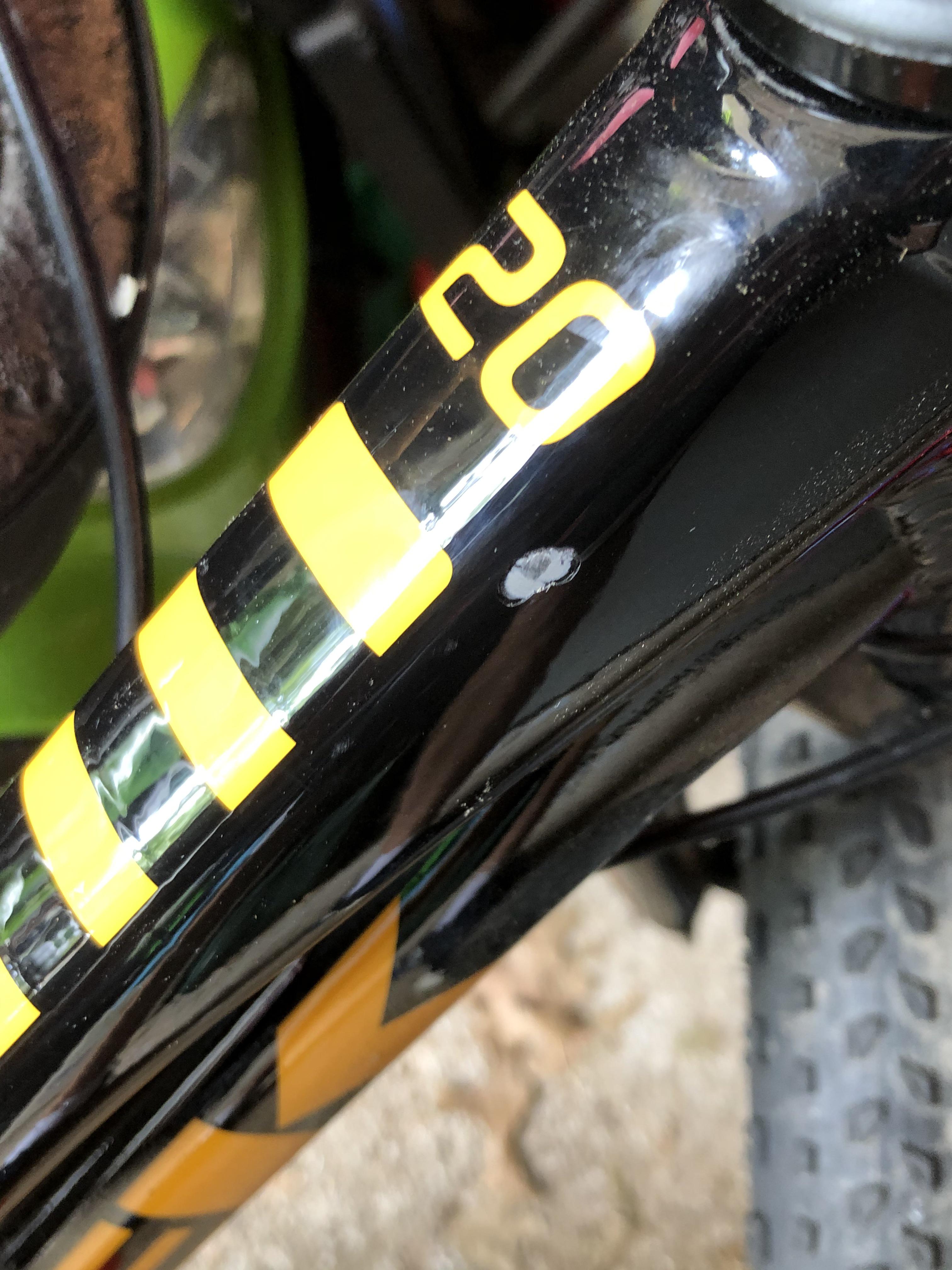 Chipped bike frame. Its actually through the paint and another layer
