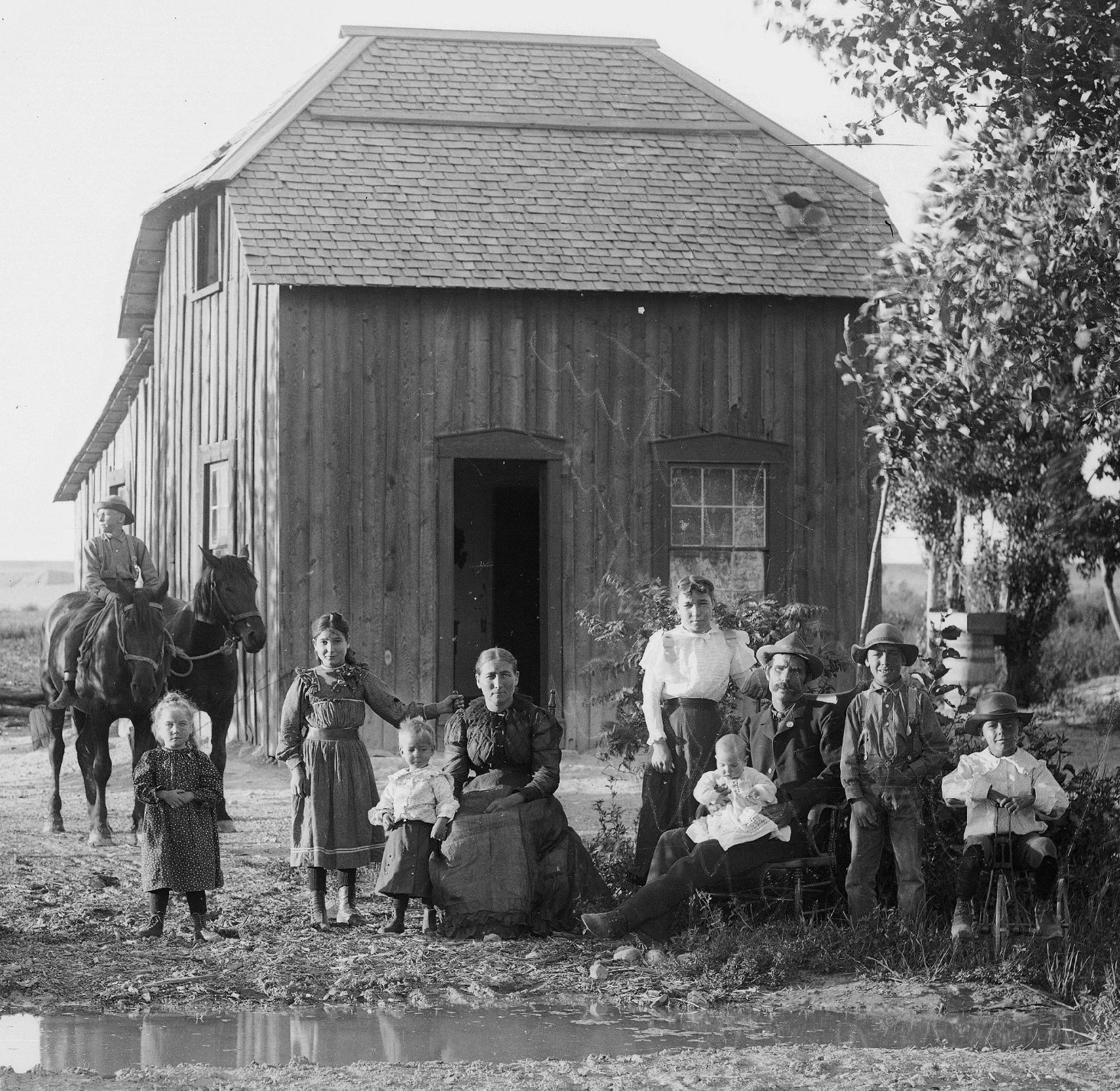 A family in front of their home in Castle Dale, Utah in 1899. r