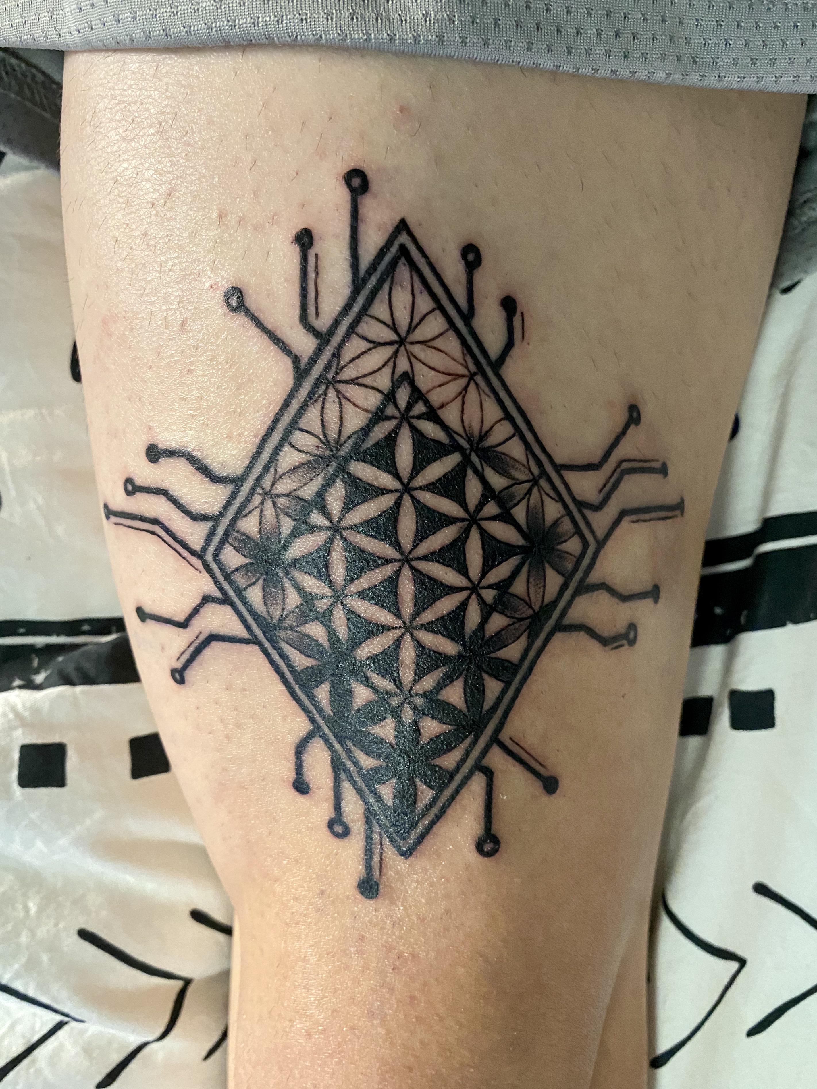Flower of Life Chip done by Jazmyn at 717 Tattoo in