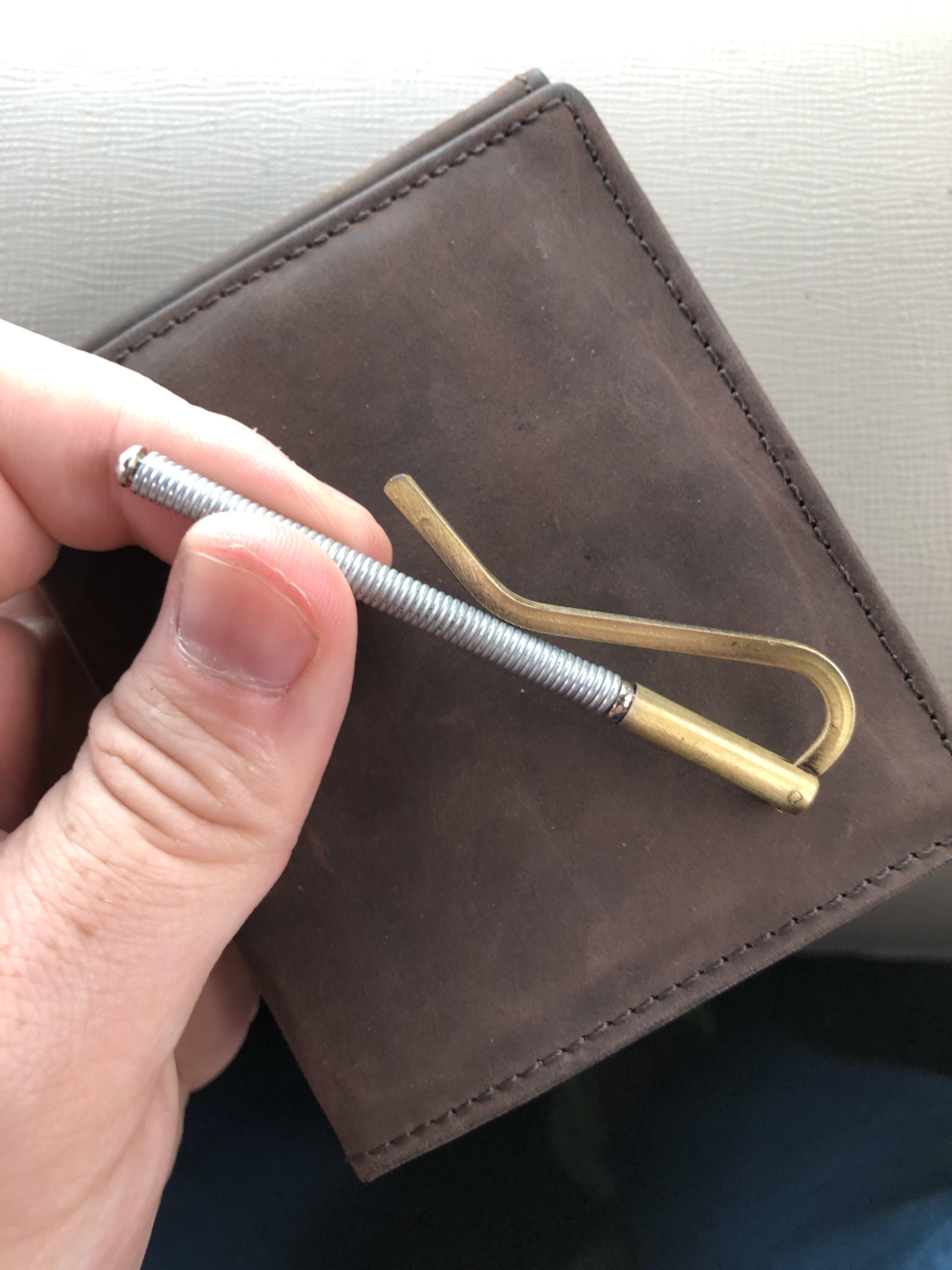 My wife bought me a wallet in Germany with this spring thing. What is