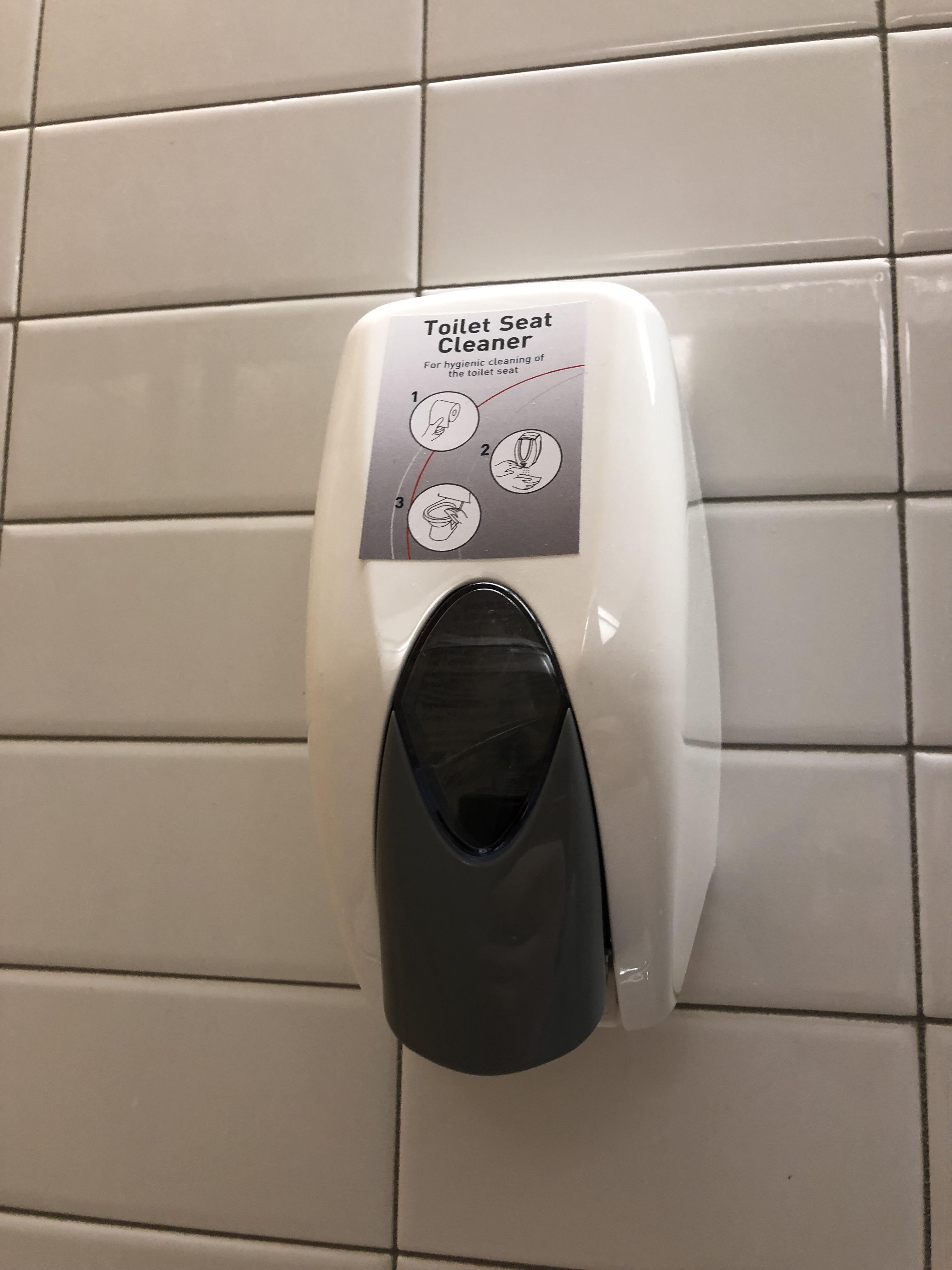Toilet seat cleaner in a bathroom stall at my university. Why are these