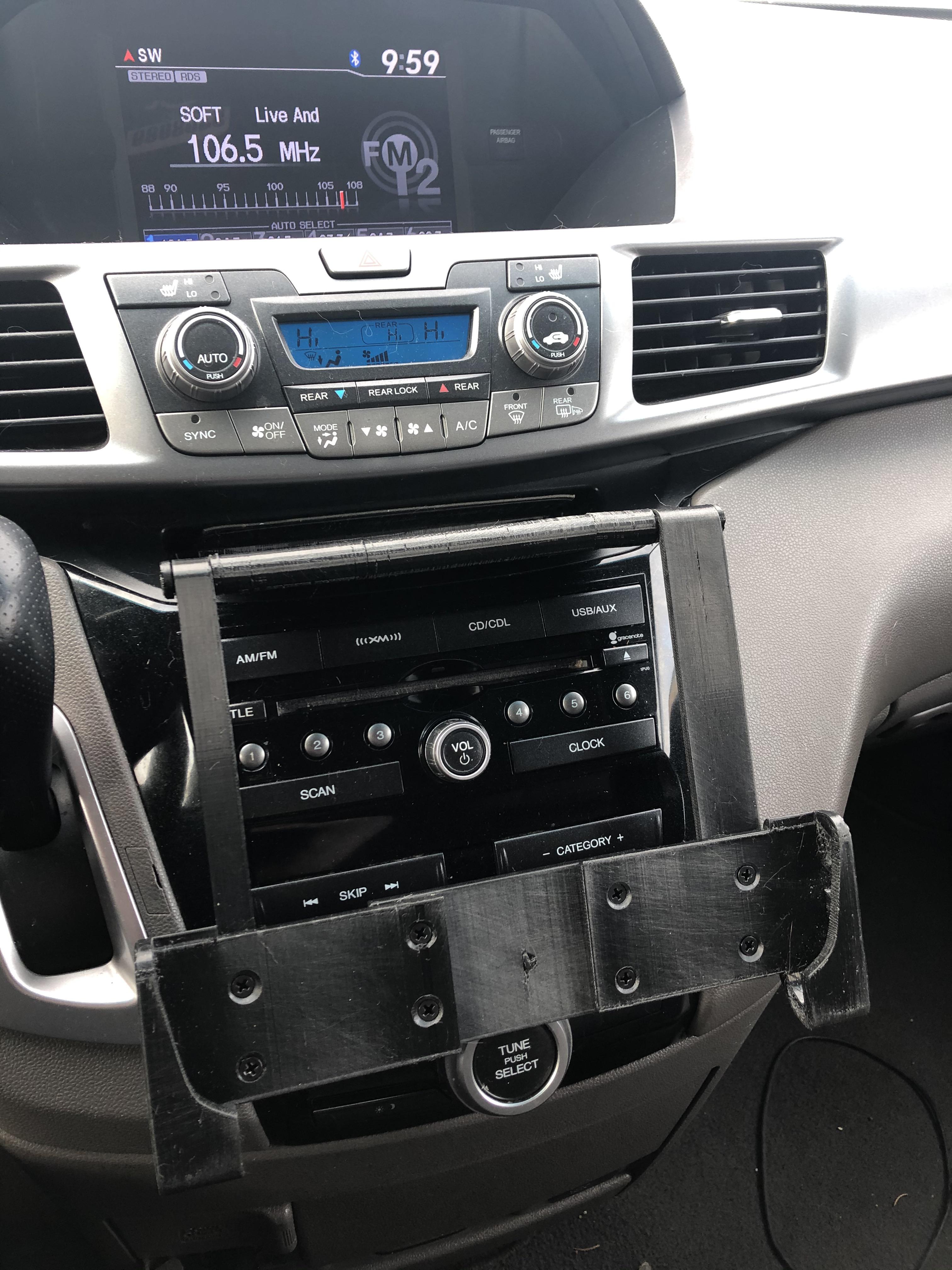 My iPad car mount. It uses the cubby above the radio as an anchor point, and has a shelf that I