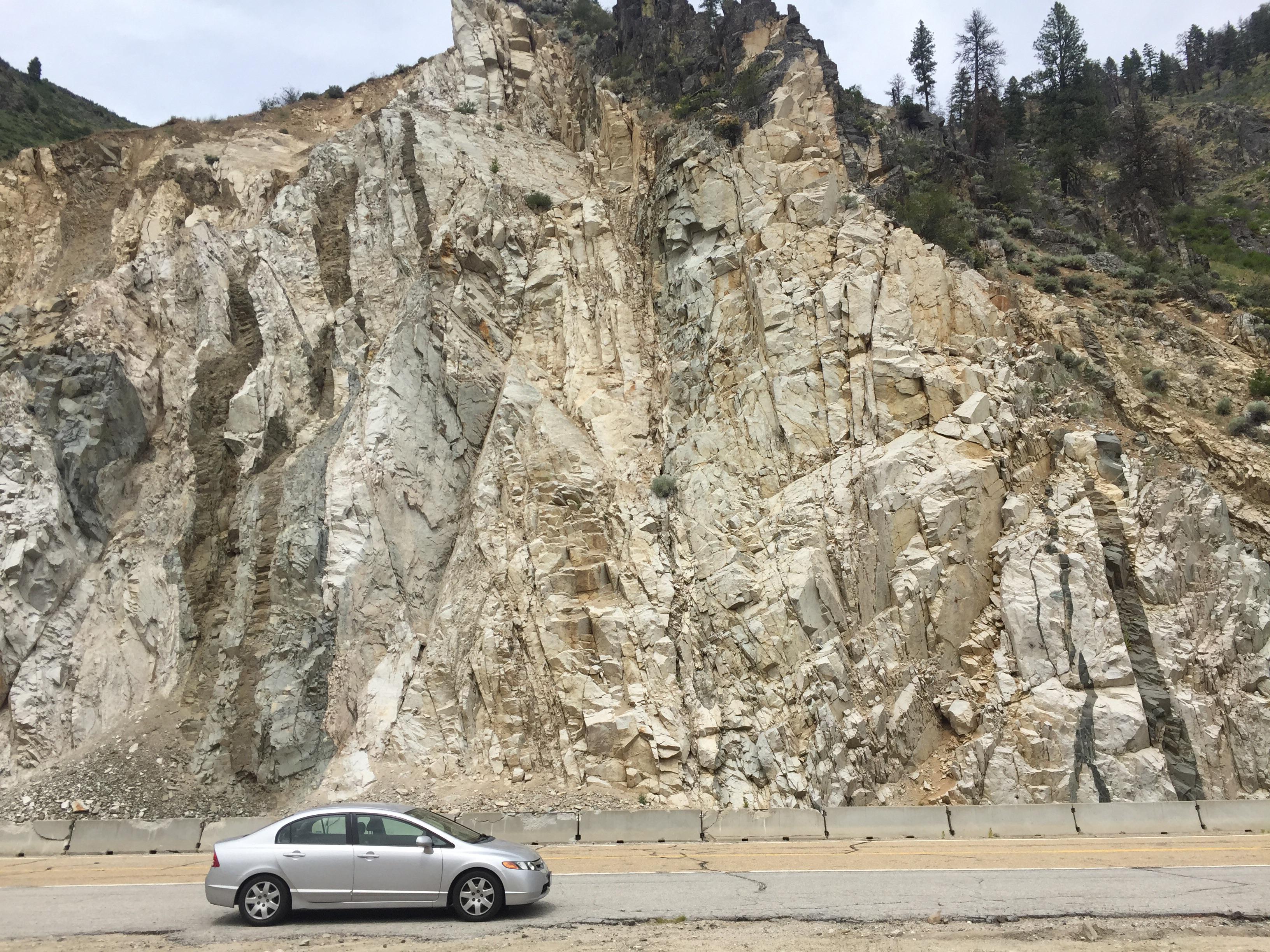 What causes vertical striations/dikes with several types of rock like