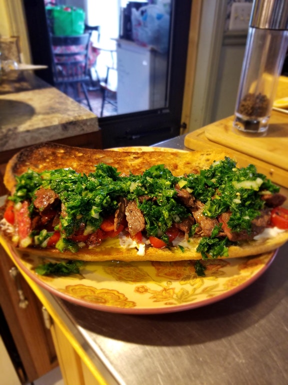 Homemade skirt steak sandwich, chimichurri, tomatoes, and mayo