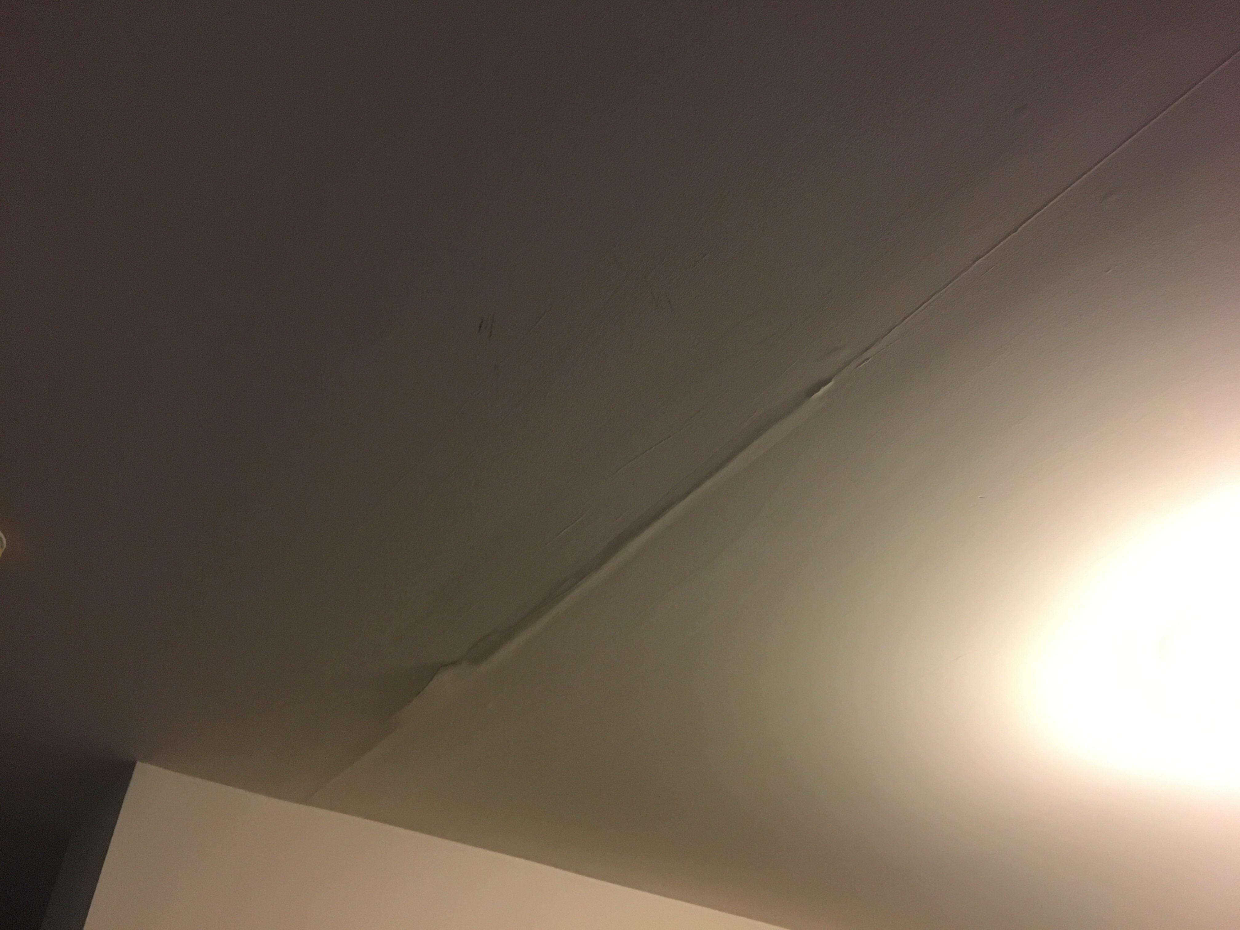 Ceiling leak damage from upstairs bathroom floor (from overflowed